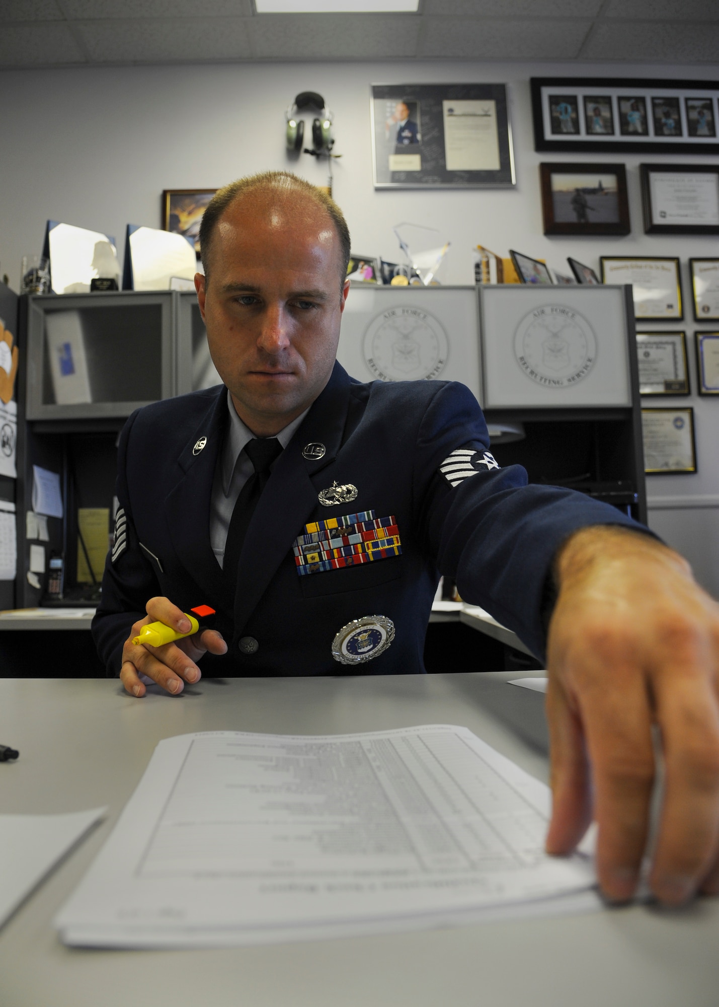 Tech. Sgt. John Vaughn, a 345th Recruiting Squadron enlisted accessions recruiter, begins the process of filling out paperwork for a potential Air Force recruit July 15, 2014, in Jacksonville, Ark. Enlisting in the Air Force can often be a tedious process, but recruiters work to ensure that motivated young men and women are able to pursue their goal of becoming Airmen. (U.S. Air Force photo by Airman 1st Class Harry Brexel)