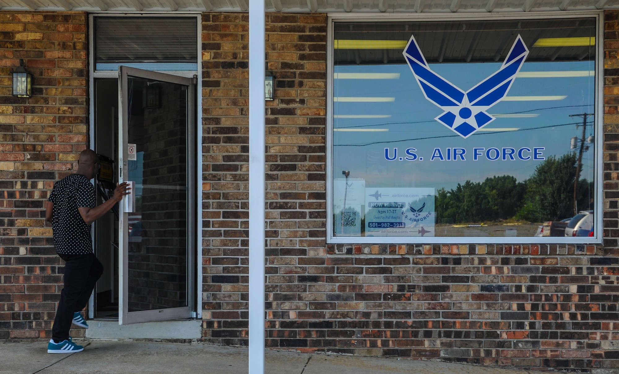 Billy Scott Jr. walks into an Air Force recruiting office to discuss his departure for basic training and his possible career options July 15, 2014, in Jacksonville, Ark. An Air Force recruiter’s office is the first stop for all enlisted Airmen. (U.S. Air Force photo by Airman 1st Class Harry Brexel) 