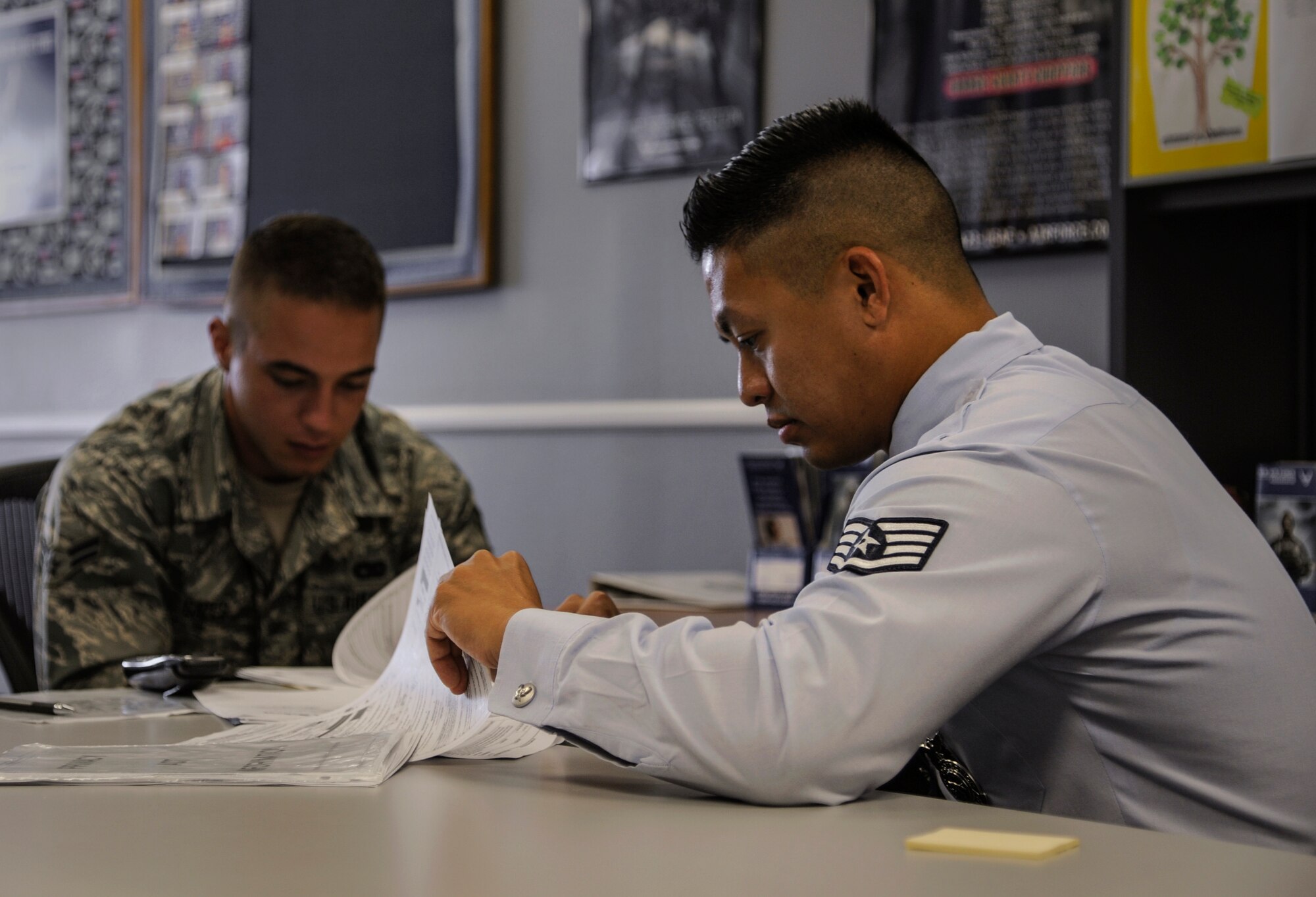 Staff Sgt. Mark Quiling, a 345th Recruiting Squadron enlisted accessions recruiter, reviews the guidelines of the Recruiter’s Assistance program with Airman 1st Class Jacob Gates, an 86th Logistics Readiness Squadron vehicle operations specialist, July 15, 2014, in Jacksonville, Ark. (U.S. Air Force photo by Airman 1st Class Harry Brexel)
