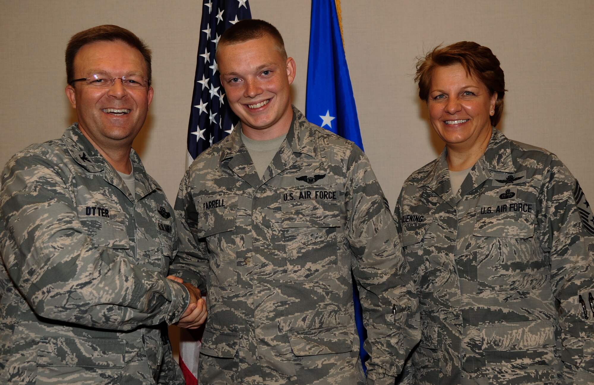 Col. William Otter, 19th Airlift Wing vice commander, and Chief Master Sgt. Rhonda Buening, 19th AW command chief, congratulate Senior Airman Tyler Farrell, a 61st Airlift Squadron C-130J loadmaster, for his selection as Combat Airlifter of the Week July 28, 2014, at Little Rock Air Force Base, Ark. Farrell, a Caldwell, Texas, native, graduated from the Advanced Airlift Tactics Training Center course, where he learned defensive maneuvers and techniques to enhance aircrew survivability in combat. (U.S. Air Force photo by Airman 1st Class Harry Brexel)