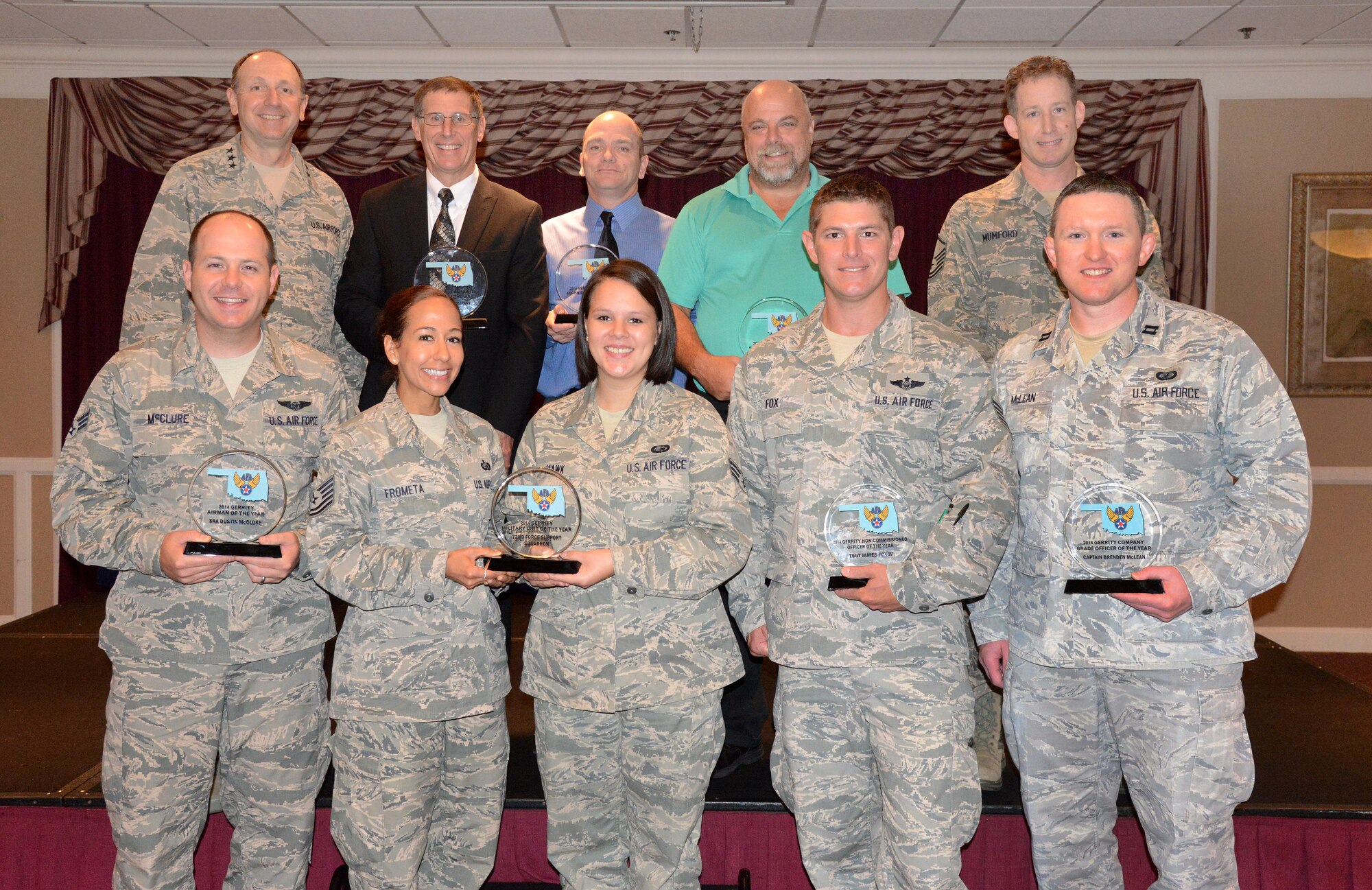 Air Force photo by Kelly White
The Air Force Association’s Gerrity Chapter held a breakfast at the Tinker Club on June 18 to honor its 2014 annual awards winners. Bottom row from left are: Airman of the Year, Senior Airman Dustin McClure from the 963rd Airborne Air Control Squadron; Tech. Sgt. Wendy Frometa and Senior Airman Danielle Hawk, accepting the award for Best Military Unit of the Year for the 72nd Force Support Squadron; Noncommissioned Officer of the Year, Tech. Sgt. James Fox from the 552nd Operations Support Squadron; and Company Grade Officer of the Year, Capt. Brenden McLean from the 552nd Operations Group. Back row from left: Guest speaker Lt. Gen. Bruce Litchfield, Air Force Sustainment Center commander; Rick Greenwell, B-1 Program manager, accepting the Gerrity Community Partner of the Year Award for The Boeing Company; Civilian Technician of the Year, Paul Herr from the 72nd Logistics Readiness Squadron; Civilian Manager of the Year, William Melton from the 72nd Operations Support Squadron; and Senior Noncommissioned Officer of the Year, Master Sgt. Michael Mumford from the 552nd Operations Support Squadron. Winners that were not present were: AFROTC Cadet Alicia K. Hendricks from the AFROTC Detachment 675, University of Oklahoma, and Nancy Bolinger, the recipient of the Maj. Gen. Billy Bowden Award. (Air Force photo by Kelly White)
