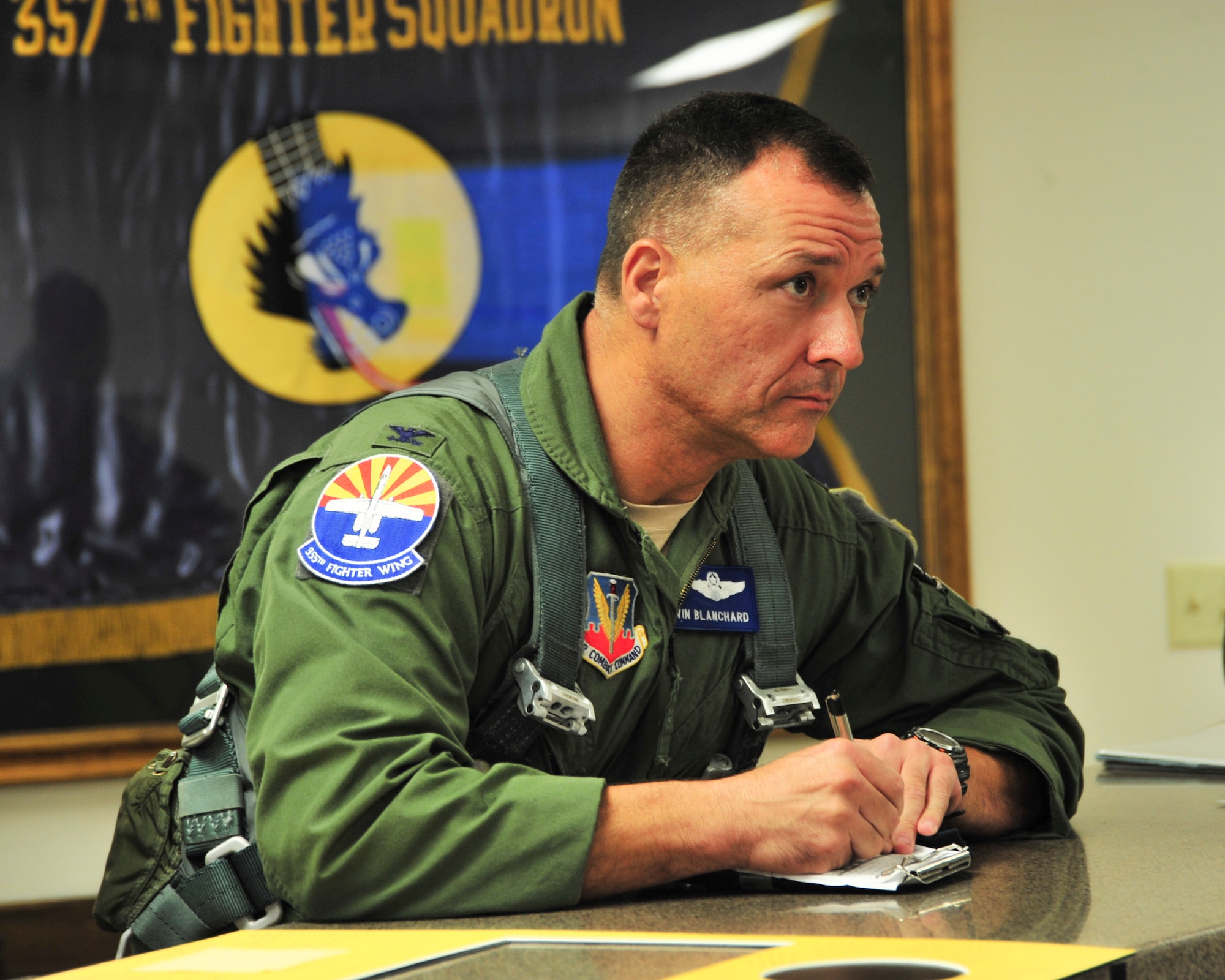 U.S. Air Force Col. Kevin E. Blanchard, 355th Fighter Wing commander, takes notes during a pre-flight briefing before his final flight in an A-10 Thunderbolt II at Davis-Monthan Air Force Base, Ariz., July 30, 2104.  Blanchard is retiring after 23 years of service.  (U.S. Air Force Photo by Airman 1st Class Chris Massey/Released)