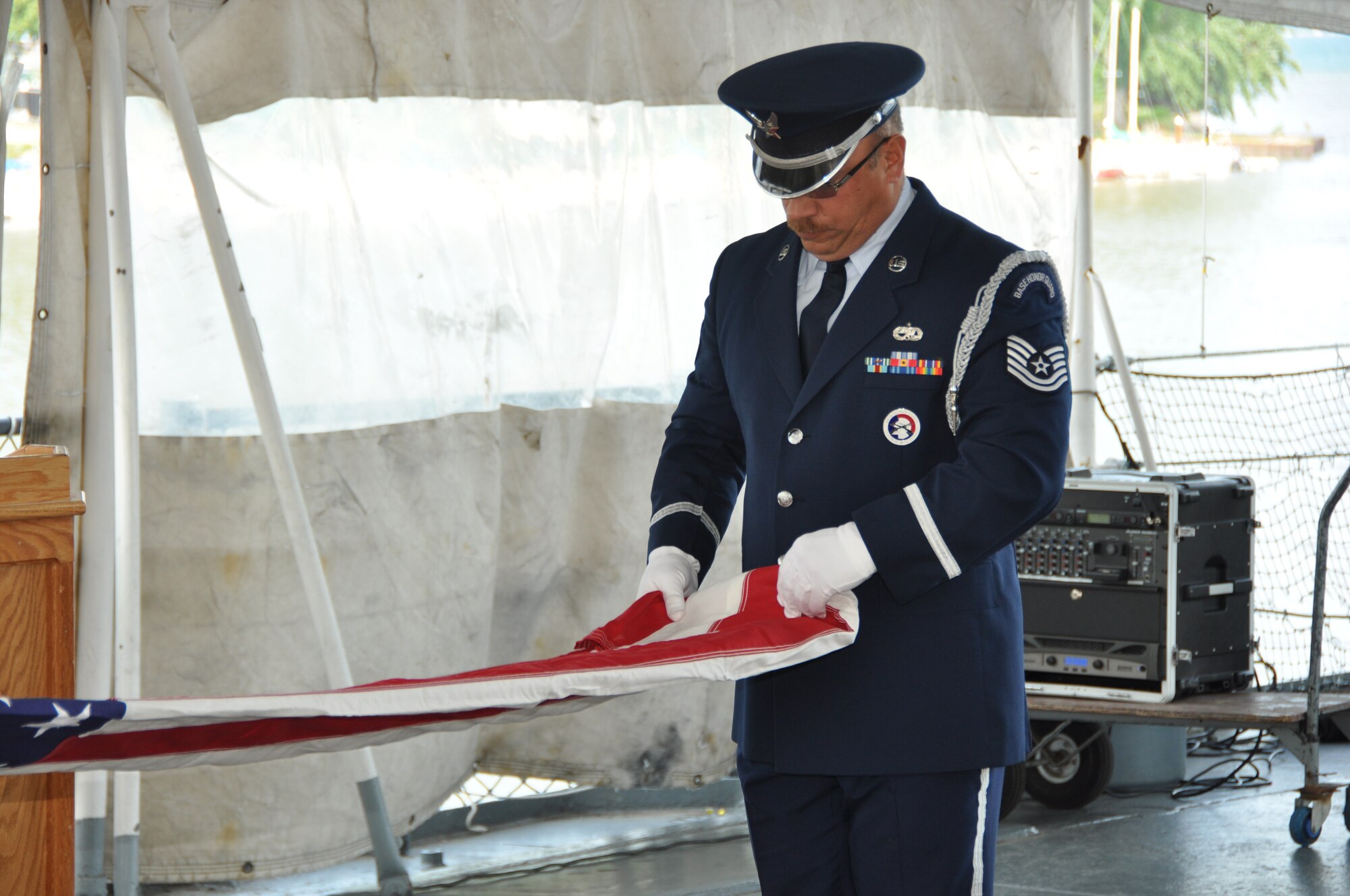 Tech. Sgt. Thomas Perreault, 914th Honor Guard member, performs a flag folding ceremony at the Buffalo and Erie County Naval and Military Park, July 25, 2014. Perreault was participating in Air Force Salute to Service Week. (U.S. Air Force photo by Staff Sgt. Stephanie Sawyer)