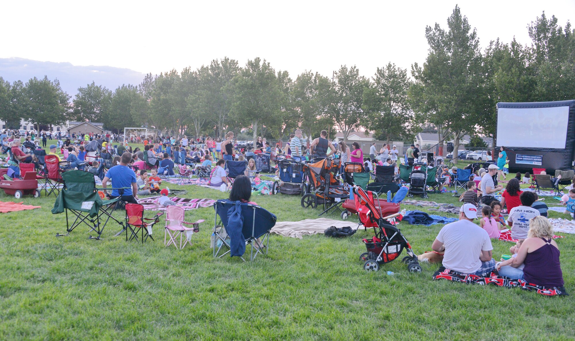 About 200 people from the base community showed up to Hardin Park July 25 to watch The Lego Movie.. Movie Under the Stars is a quarterly wing event, with Kirtland Federal Credit Union and Kirtland Family Housing supplying pizza, popcorn, snow cones and other treats. (Photo by Dennis Carlson)