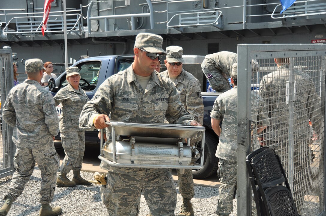 Airman 1st Class Dominick Lisek, 914 Force Support Squadron, services, unloads equipment at the Buffalo and Erie County Naval and Military Park, July 25, 2014. Lisek was helping set up the Single Palletized Expeditionary Kitchen (SPEK) display for Air Force Salute to Service Week. (U.S. Air Force photo by Staff Sgt. Stephanie Sawyer)