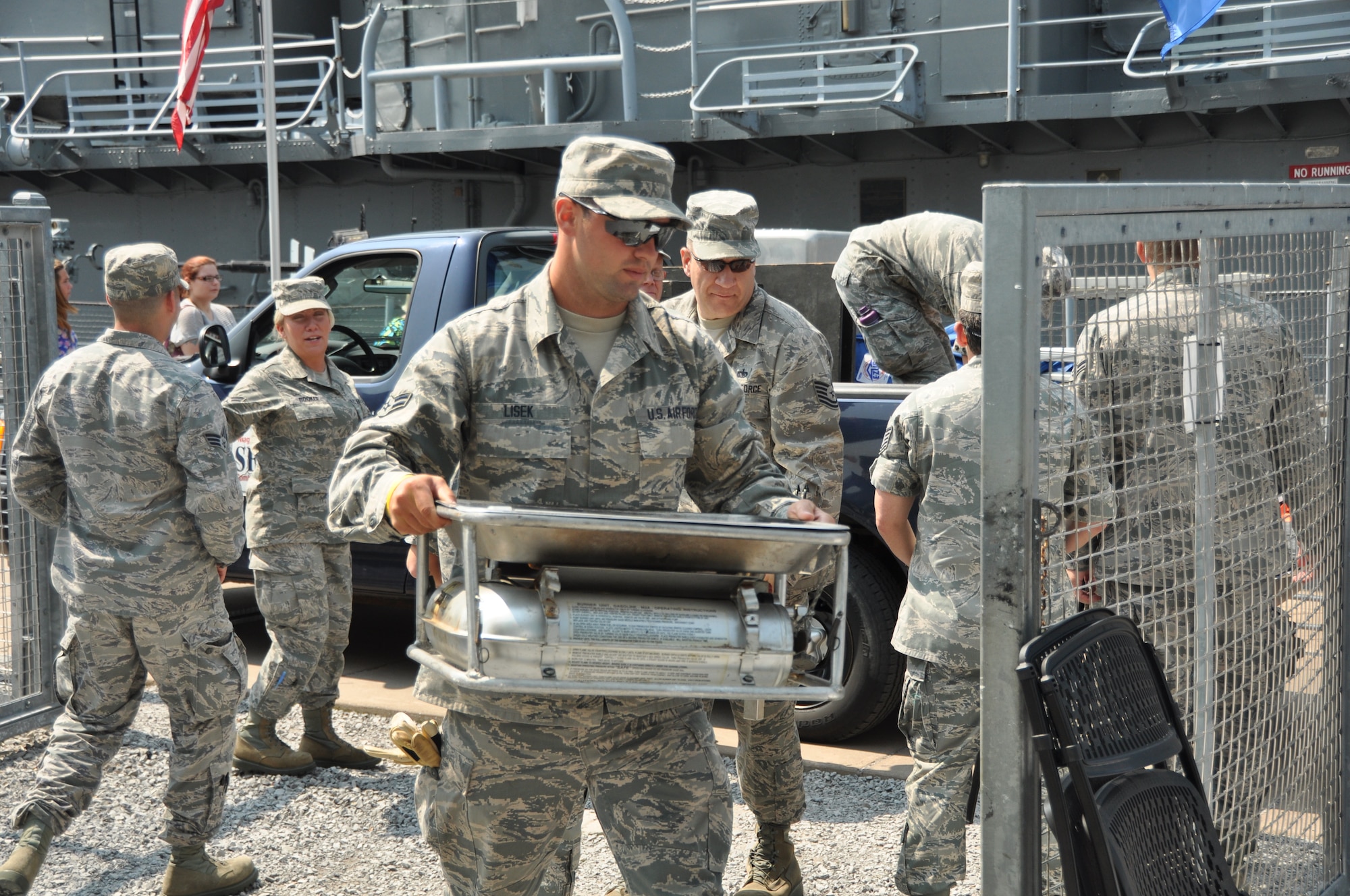 Airman 1st Class Dominick Lisek, 914 Force Support Squadron, services, unloads equipment at the Buffalo and Erie County Naval and Military Park, July 25, 2014. Lisek was helping set up the Single Palletized Expeditionary Kitchen (SPEK) display for Air Force Salute to Service Week. (U.S. Air Force photo by Staff Sgt. Stephanie Sawyer)