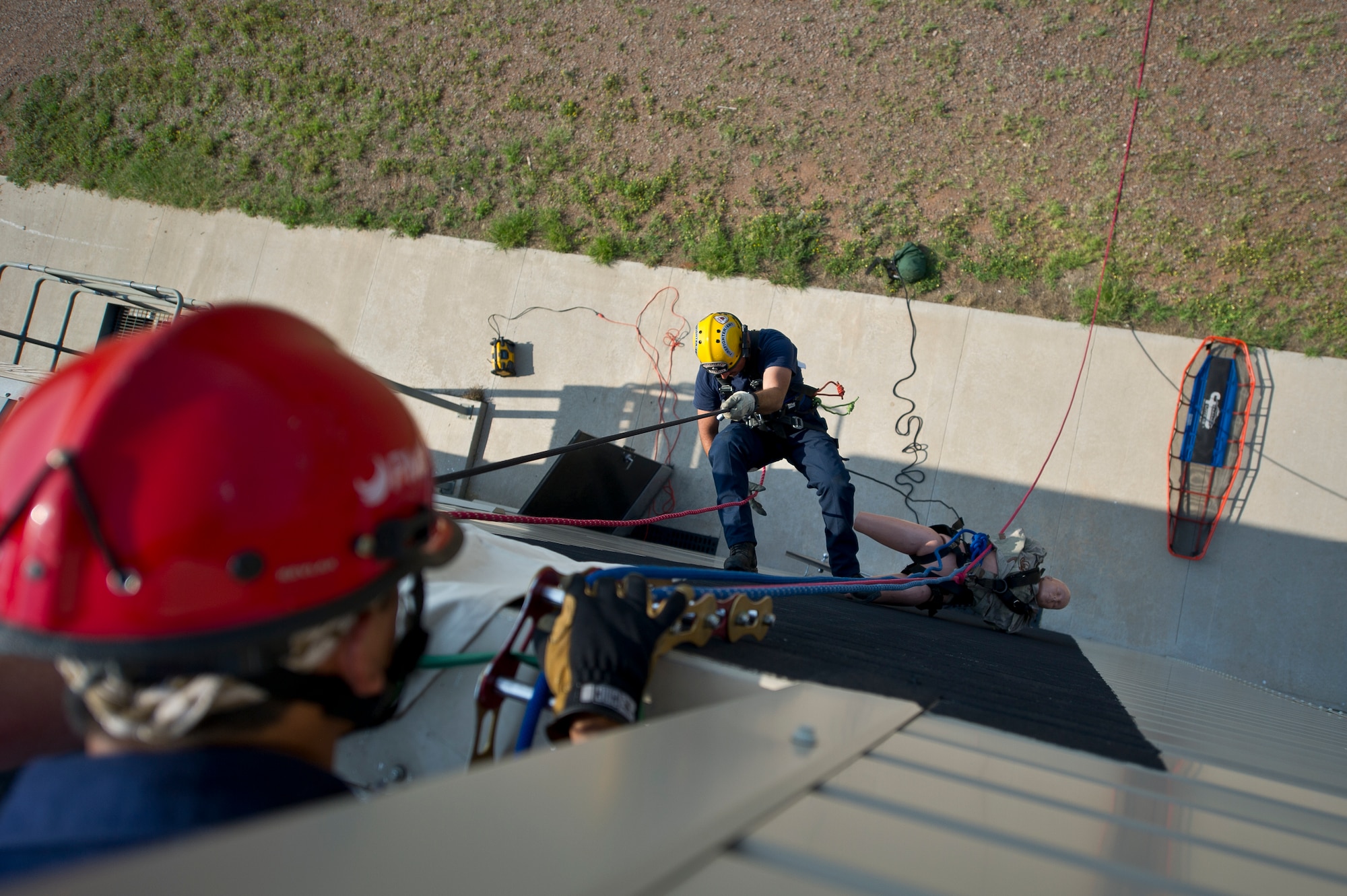 ALTUS AIR FORCE BASE, Okla. – A firefighter from the 97th Civil Engineer Squadron fire department rappels down the side of a building to rescue a simulated-incapacitated victim during a Department of Defense Rescue Technician Course July 22, 2014. The simulated rescue exercise provided students with a hands-on approach to learning high and low-angle rescue operations. (U.S. Air Force photo by Senior Airman Dillon Davis/Released)