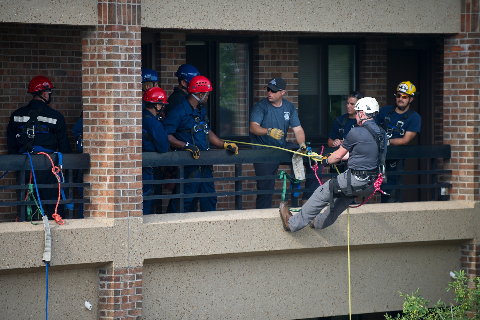 ALTUS AIR FORCE BASE, Okla. – U.S. Marine Corps Staff Sgt. DeWayne Meats, Lewis F. Garland Department of Defense Fire Academy instructor, Goodfellow Air Force Base, Texas, demonstrates how to rappel safely down the side of a building during a DOD Rescue Technician Course July 22, 2014. The joint training course provided students with training in high and low-angle rescue operations as well as confined spaces rescue qualifications. (U.S. Air Force photo by Senior Airman Dillon Davis/Released)