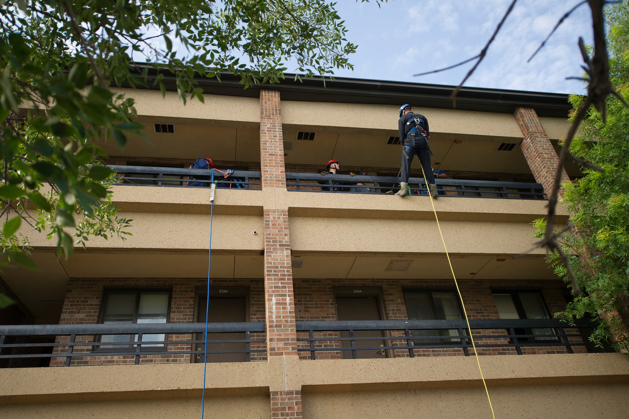 ALTUS AIR FORCE BASE, Okla. – A firefighter from the 97th Civil Engineer Squadron rappels down the side of a building during a Department of Defense Rescue Technician Course July 22, 2014. The joint training course covered a variety of elevated rescue operations in addition to confined spaces rescue training. (U.S. Air Force photo by Senior Airman Dillon Davis/Released)