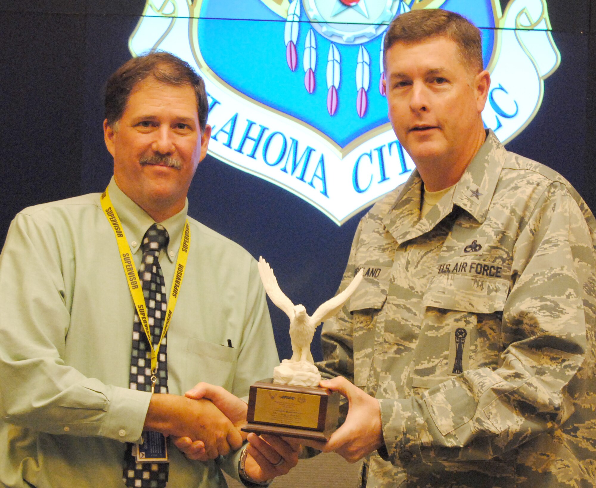 Oklahoma City Air Logistics Complex Commander Brig. Gen. Gene Kirkland presents the Production Member of the Year award to Craig Rayner, 564th Aircraft Maintenance Squadron Production Flight chief. Mr. Rayner’s outstanding leadership of 1,200 production personnel, and in support of a 1,400-person strong organization, enabled the squadron to produce 60 KC-135 aircraft, three aircraft above the annual contract. Additionally, using tools such as Enterprise Value Stream Analysis, Mr. Rayner identified constraints to aircraft production and developed work scripting and gated processes resulting in the early delivery of 60 KC-135 aircraft.