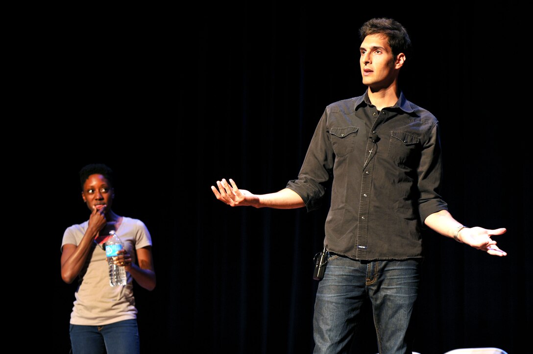 From left, Sakinah Smith and Chris Beier perform a skit during the improvisational comedy show, “Sex Signals,” inside Jacobs Theater at Fort Eustis, July 30, 2014. The show challenged audiences to recognize misconceptions about coercive behaviors and stereotypes, and used improvisational acting to reexamine cultural situations that lead to sexual assault. (U.S. Air Force photo by Staff Sgt. Katie Gar Ward/Released)