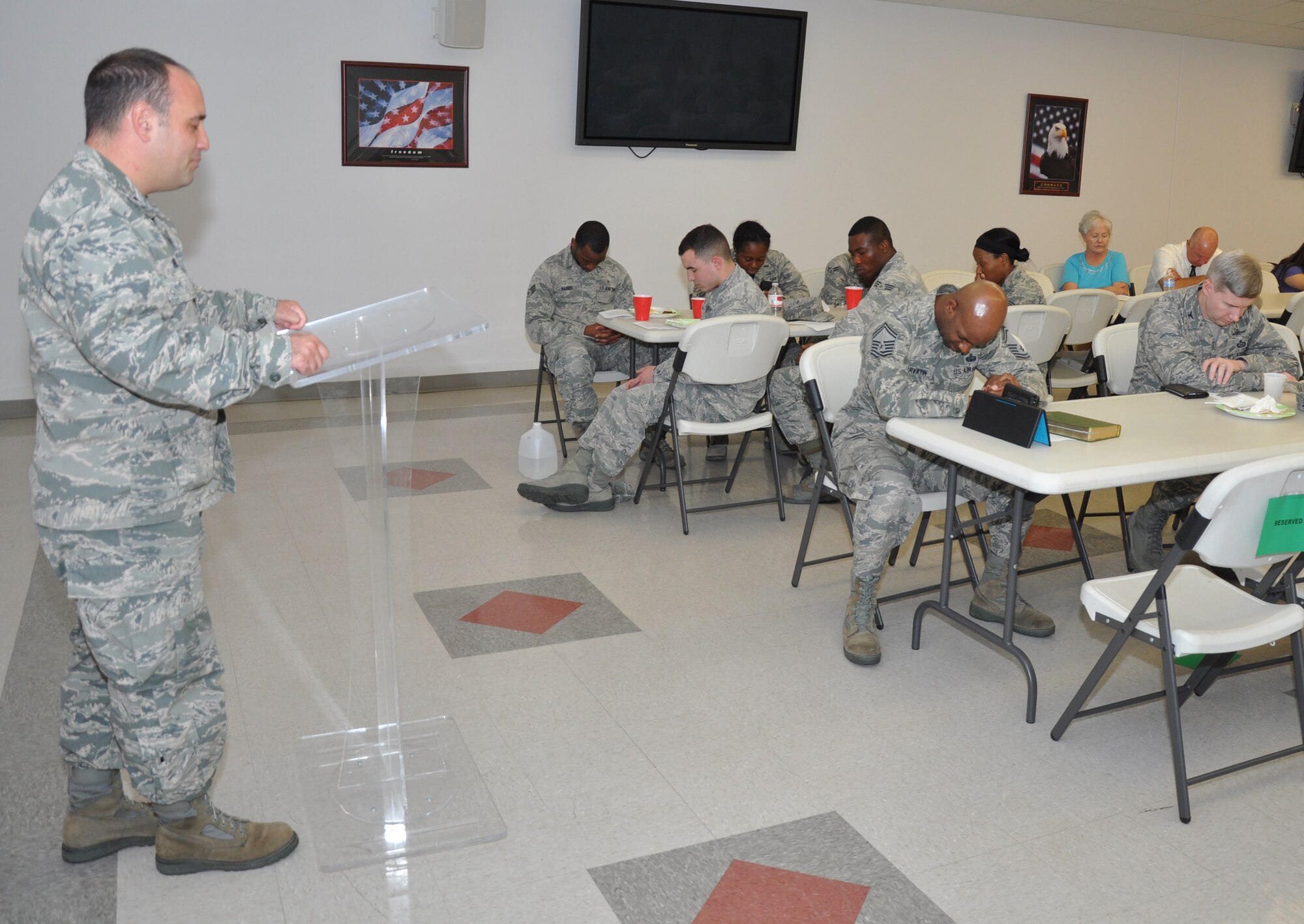 GOODFELLOW AIR FORCE BASE, Texas – Chaplain (Capt.) James M. Henry, 17th Training Wing, provides the benediction during the 344th Military Intelligence Battalion Prayer Luncheon at the Fellowship Hall here July 25. Henry, Chaplain (Capt.) Patrick D. Ireland, 344th MI BN and Senior Master Sgt. David L. Harvatin, 17th Training Wing Special Plans and Programs superintendent and Knowledge Operations manager, all spoke at the event. (U.S. Air Force photo/ Senior Airman Joshua Edwards)