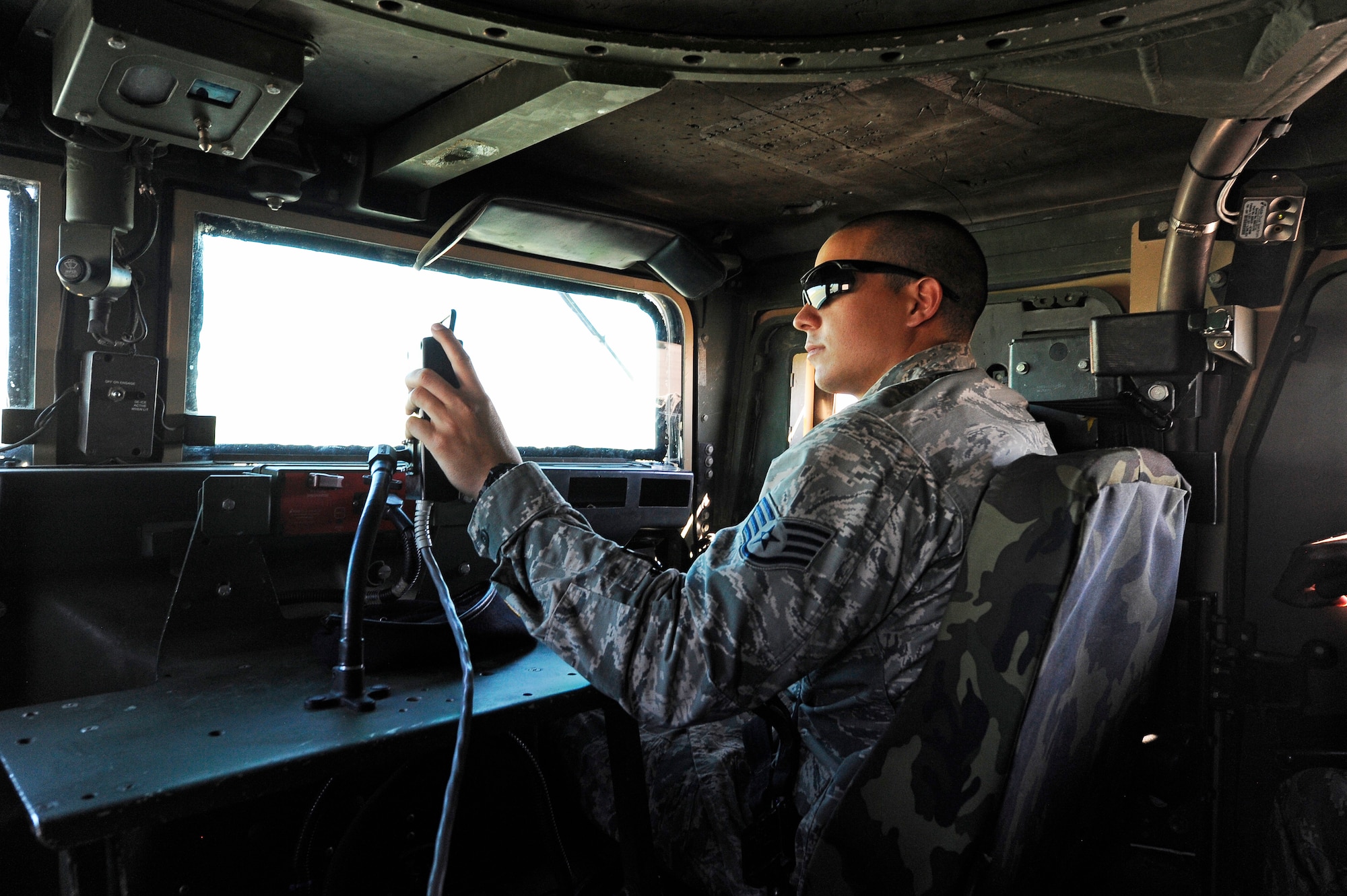 Staff Sgt. Cody Berry, 341st Security Forces Group trainer, manipulates a skid from the passenger seat of an up-armored Humvee July 30. In order to provide the most accurate training, Instructors use a variety of techniques to simulate various road conditions while students navigate a pre-determined road course. (U.S. Air Force photo/Airman 1st Class Collin Schmidt)