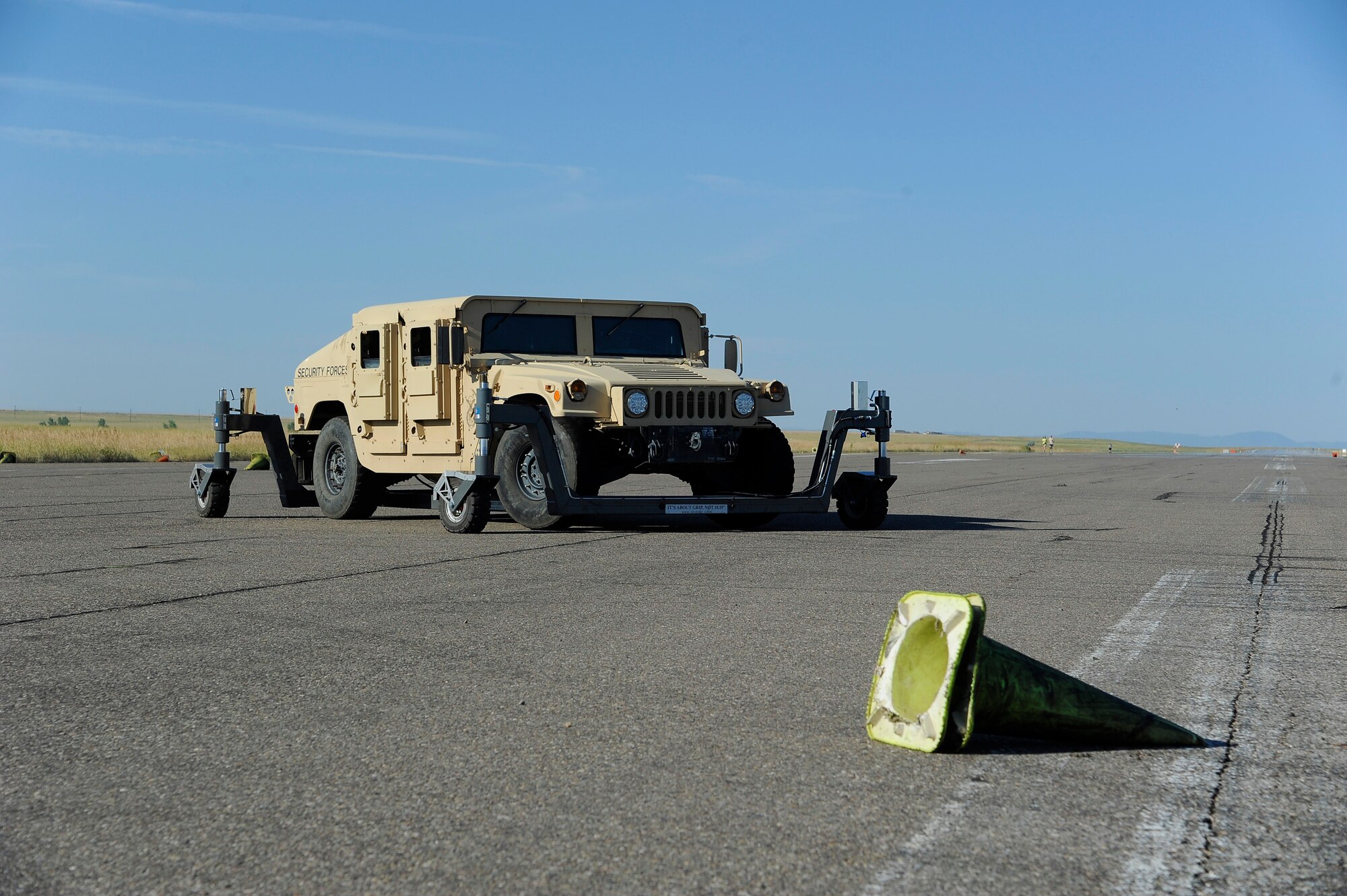 A skid training platform, also known as a ‘skid monster,’ is attached to the undercarriage of an up-armored Humvee for a training session on Malmstrom Air Force Base’s decommissioned flightline July 30. Skid trainers allow drivers to experience various road conditions while in a controlled training environment. (U.S. Air Force photo/Airman 1st Class Collin Schmidt)