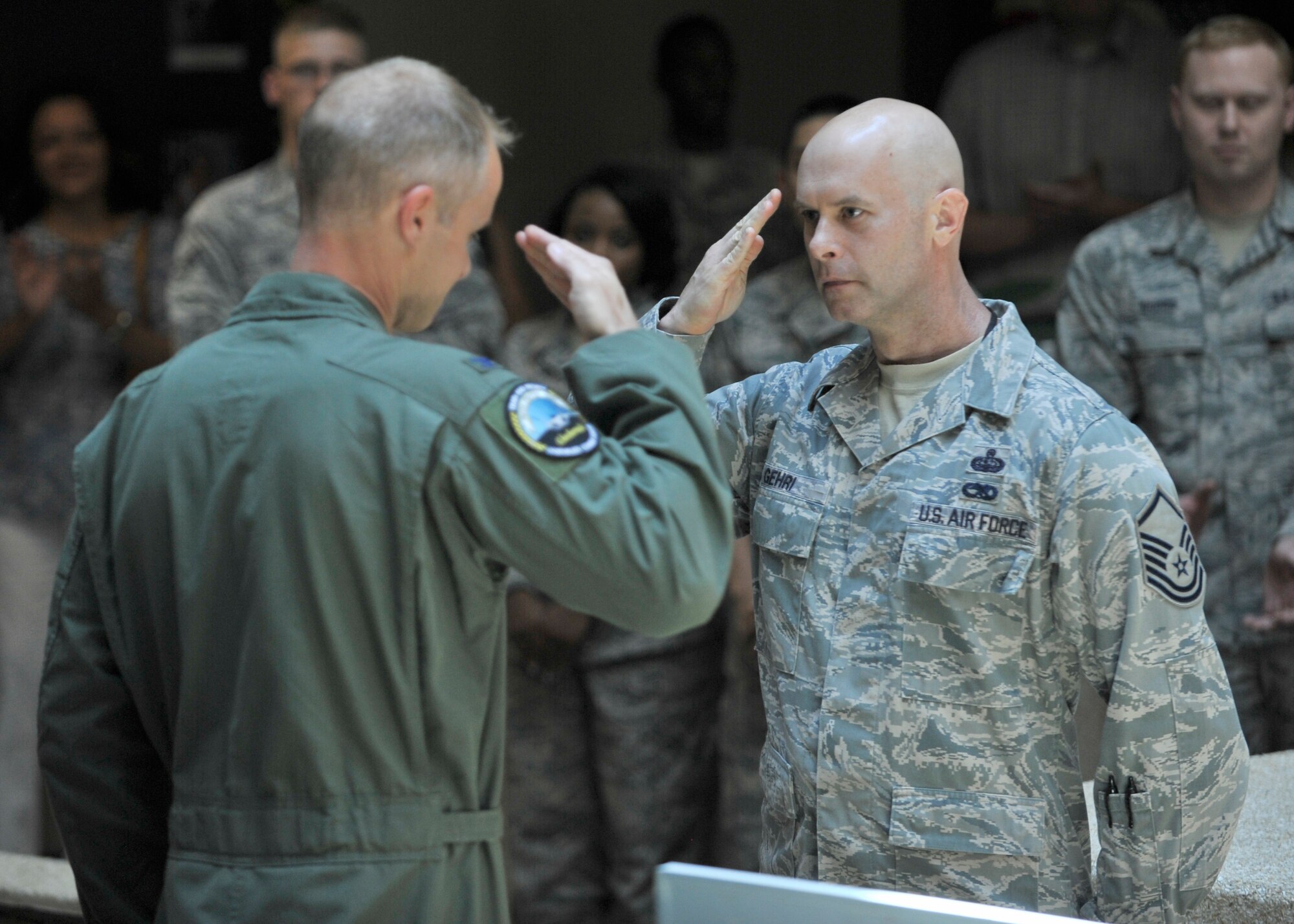 Master Sgt. Sean Gehri,101st Air Communications Squadron renders a salute to Col. Derek France, 325th Fighter Wing commander, during a ceremony recognizing superior performers for the recent Command Cyber Readiness Inspection. Gehri received a coin from the commander. While the 325th FW was the unit inspected, the communications requirements for the 601st Air and Space Operations Center and Air Forces Northern multiple networks represent one of  the wing's largest.