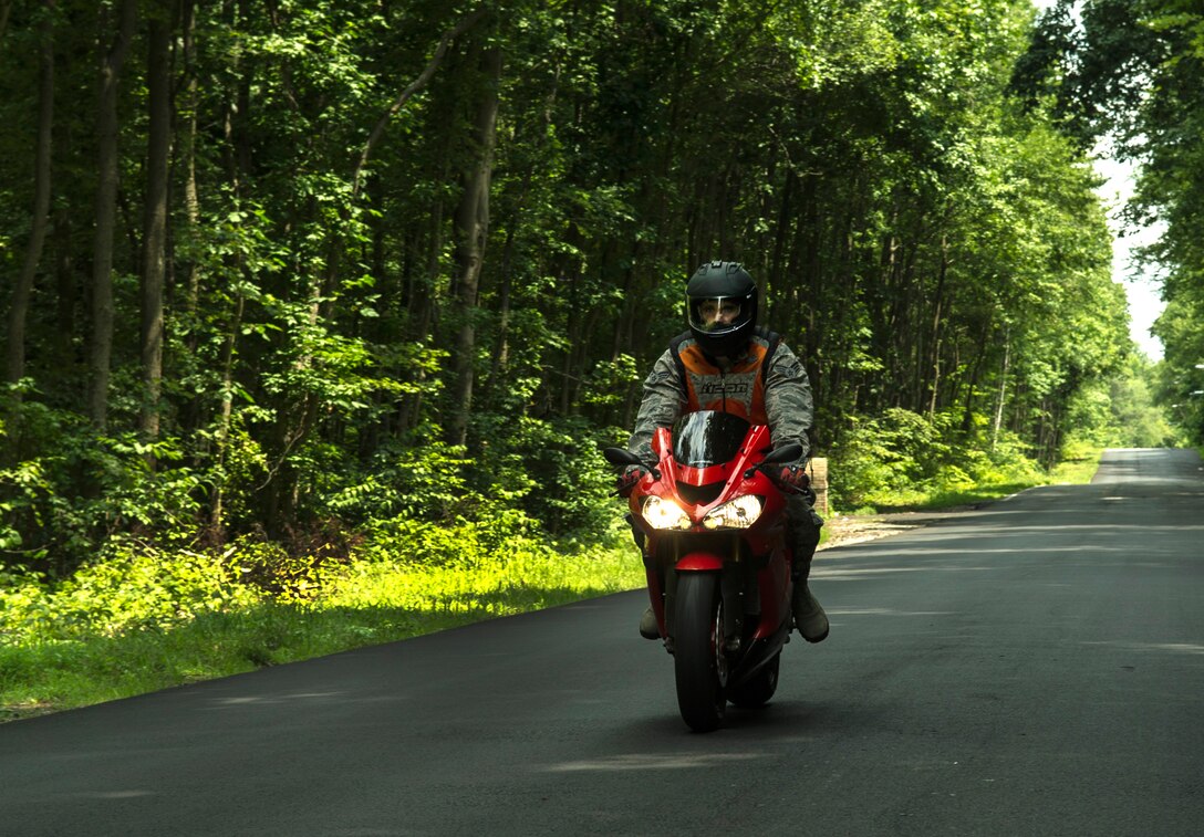 Senior Airman AJ Ritterbeck, 811th Security Forces Squadron Vice-Presidential aircraft security protective services specialist, rides his newest motorcycle on a secluded country road near Joint Base Andrews, Md., July 30, 2014. Ritterbeck volunteers as a motorcycle safety instructor and assistant safety representative for his unit.(U.S. Ai r Force photo/Senior Airman Mariah Haddenham)