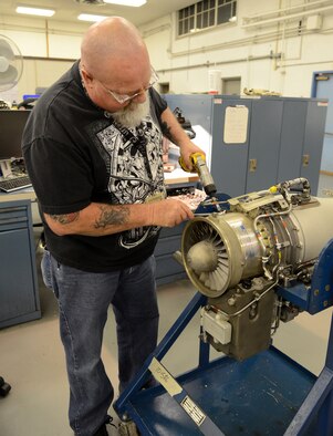 Work leader Mike Harris, 550th Commodities Maintenance Squadron, overhauls the F107 engine for the cruise missile to get it ready for testing. Tinker’s Cruise Missile Shop is the only one of its kind in the Air Force. (Air Force photo by Kelly White)