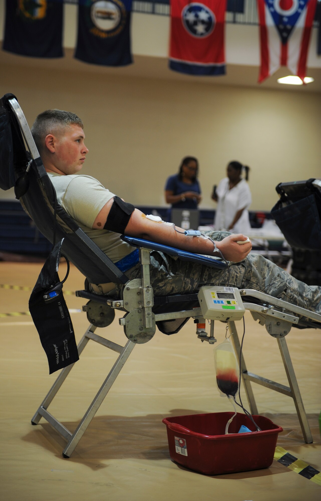 U.S. Air Force Airman 1st Class James Rawls, 23d Component Maintenance Squadron aircraft fuel systems journeyman, sits while donating blood at Moody Air Force Base, Ga., July 30, 2014. During donation, a collection bag attached to a scale beeps to let the technician know when it’s reached maximum weight. (U.S. Air Force photo by Airman 1st Class Alexis Millican/Released)  
