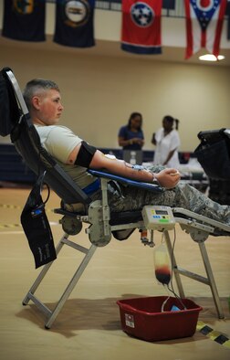 U.S. Air Force Airman 1st Class James Rawls, 23d Component Maintenance Squadron aircraft fuel systems journeyman, sits while donating blood at Moody Air Force Base, Ga., July 30, 2014. During donation, a collection bag attached to a scale beeps to let the technician know when it’s reached maximum weight. (U.S. Air Force photo by Airman 1st Class Alexis Millican/Released)  
