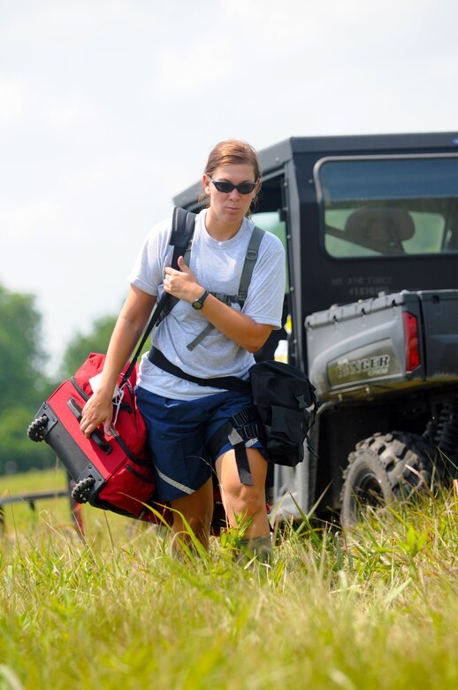 U.S. Air Force Tech. Sgt. Jennifer Krystek carries equipment during Joint Exercise Vibrant Response July 22, 2014 at Camp Atterbury, Ind. Sgt. Krystek is a member of the 121st Air Refueling Wing Force Support Squadron assigned to the Fatality Search and Recovery team. (U.S. Air National Guard photo by Master Sgt. Ralph Branson)