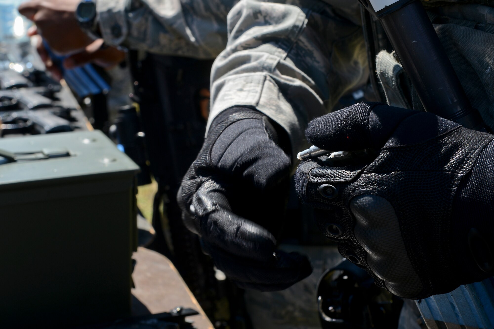 48th Security Forces Squadron Airmen load ammunition before a high-valued target scenario during force-on-force training at the Stanford Training Area in Norfolk, England, July 29, 2014. Defenders from the 48th SFS conducted a day of training at STANTA, an area that offers a realistic environment for Airmen to train. (U.S. Air Force photo by Airman 1st Class Trevor T. McBride)