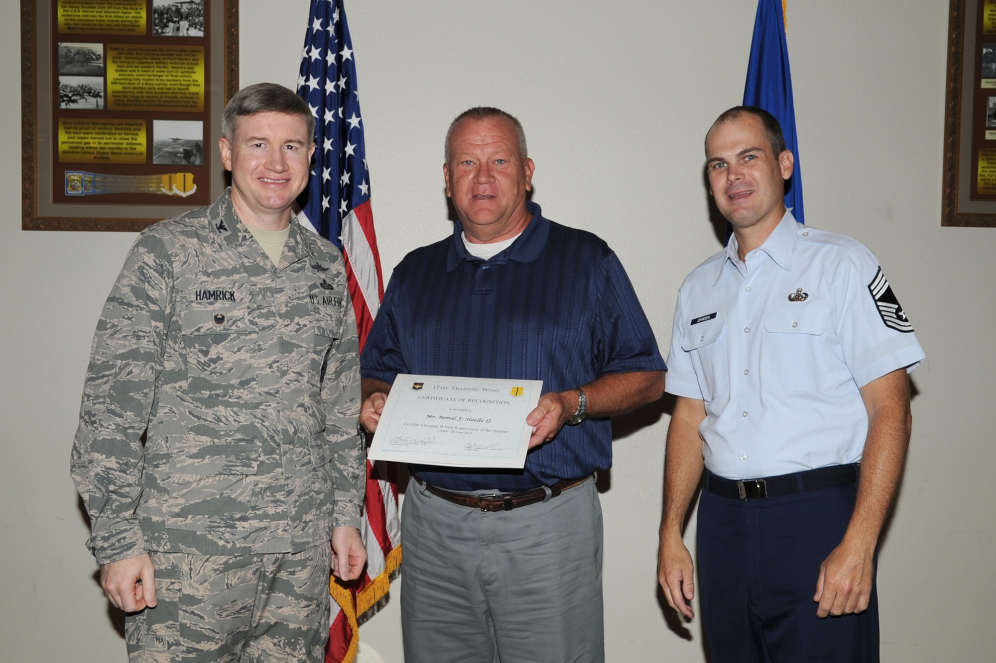 GOODFELLOW AIR FORCE BASE, Texas - Col. Terry J. Hamrick Jr., 17th Training Wing Vice Commander, and Chief Master Sgt. Matthew K. Johnson, 17th Mission Support Group superintendent, present the 17th Training Wing Civilian Category II Non-supervisory of the Quarter award to Ronald F. Hoelle, 312th Training Squadron, during the wing quarterly awards ceremony at the Event Center here July 21. (U.S. Air Force photo/Staff Sgt. Laura R. McFarlane)