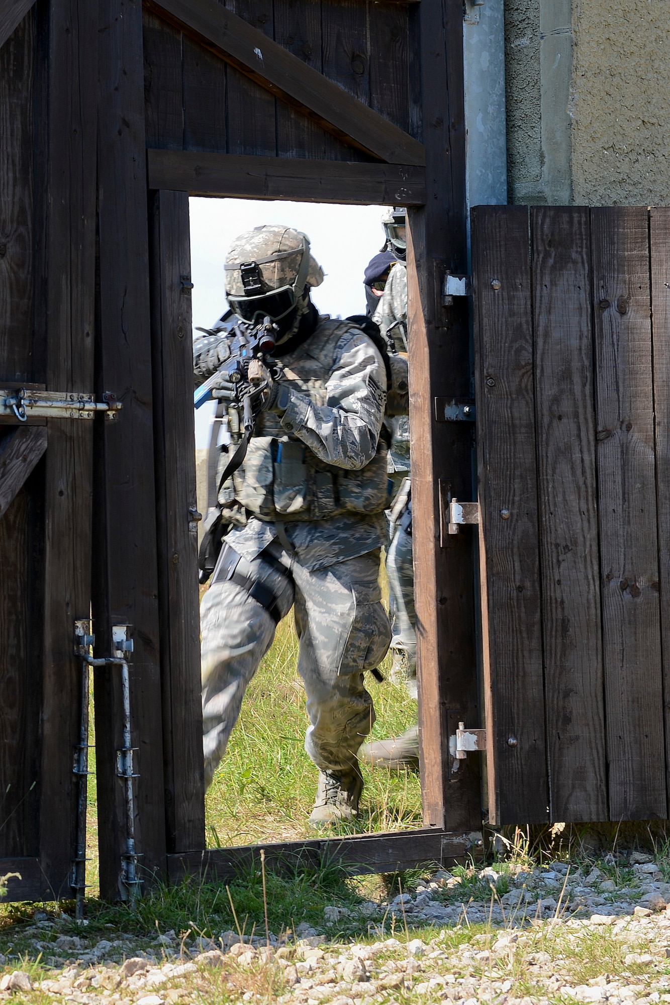 Senior Airman Richard Ringenbach, 48th Security Forces Squadron response force member, breaches a gate utilizing specific tactics in a high-valued target scenario during force-on-force training at the Stanford Training Area in Norfolk, England, July 29, 2014. Defenders from the 48th SFS conducted a day of training at STANTA, an area that offers a realistic environment for Airmen to train. (U.S. Air Force photo by Airman 1st Class Trevor T. McBride)