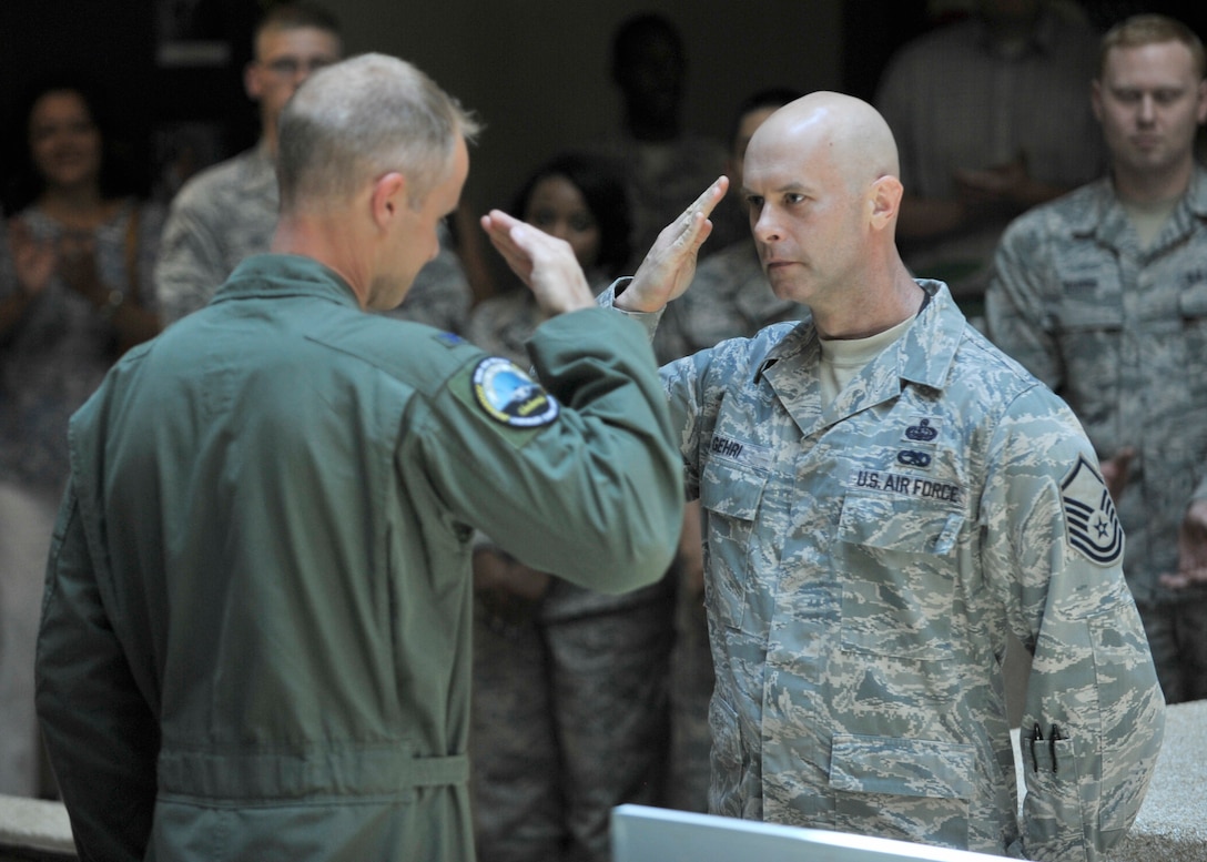 Col. Derek France, 325th Fighter Wing commander, coins Master Sgt. Sean Gehri, 101st Air Communications Squadron NCOIC of C2 Systems, for his assistance supporting the 325th Communications Squadron's preparation for the recent Command Cyber Readiness Inspection. While the 325th FW was the unit being inspected, the communications requirements for the 601st Air and Space Operations Center and Air Forces Northern multiple networks are one of  the wing's largest of all Tyndall's tenet units. The base received an excellent in the CCRI.  (Photo by A1C Sergio Gamboa)

