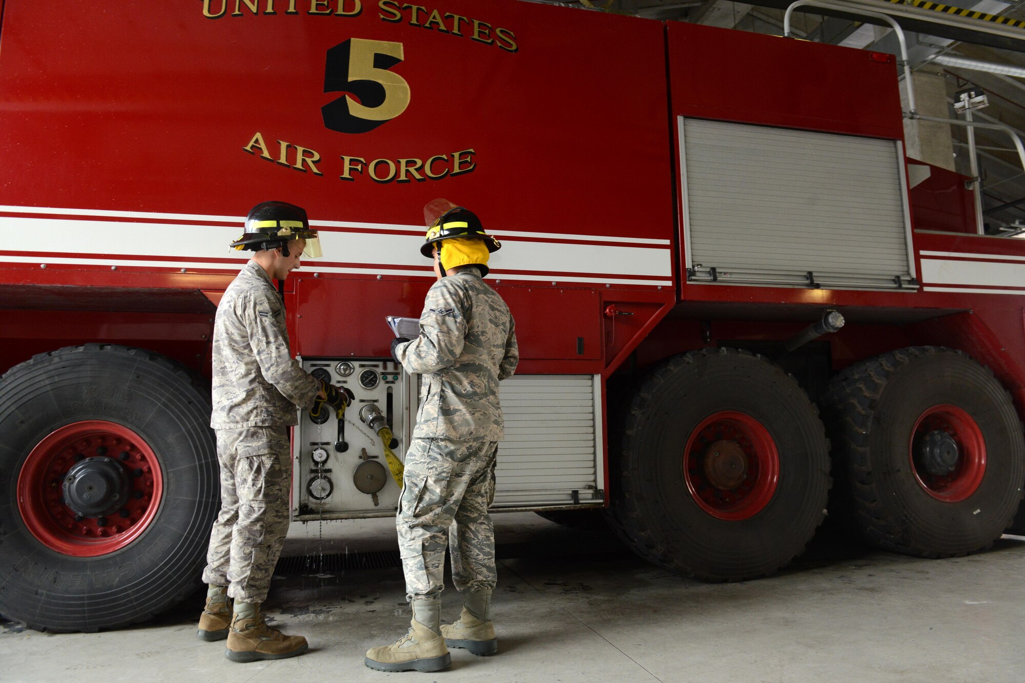 Airman 1st Class Joseph Cappel performs checks on a crash truck with Airman Victor Miranda-Ortiz, July 29, 2014, at Aviano Air Base, Italy.  At the beginning of a 24-hour shift, firefighters conduct checks on the trucks to always be prepared for when they receive an emergency call. Cappel and Miranda-Ortiz are 31st Civil Engineer Squadron firefighters. (U.S. Air Force photo/Airman 1st Class Ryan Conroy) 