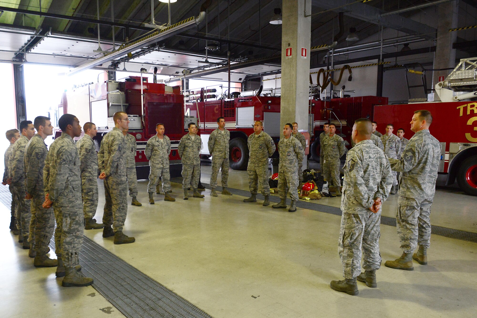Firefighters from the 31st Civil Engineer Squadron line up for morning roll call, July 29, 2014, at Aviano Air Base, Italy. During roll call, the station chief addresses both shifts with any concerns and each shift relays important information before being dismissed to go home or begin checks. (U.S. Air Force photo/Airman 1st Class Ryan Conroy) 