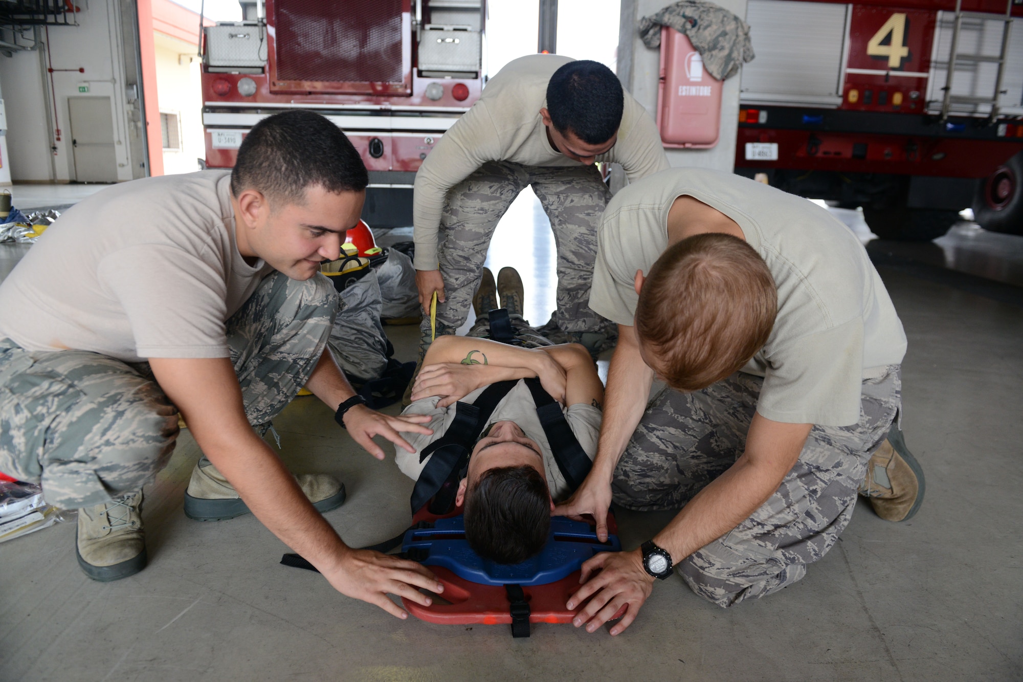 Firefighters from the 31st Civil Engineer Squadron practice boarding a patient during emergency medical response training, July 29, 2014, at Aviano Air Base, Italy. As first responders, firefighters must be knowledgeable in emergency medical care and cardiopulmonary resuscitation.  (U.S. Air Force photo/Airman 1st Class Ryan Conroy) 