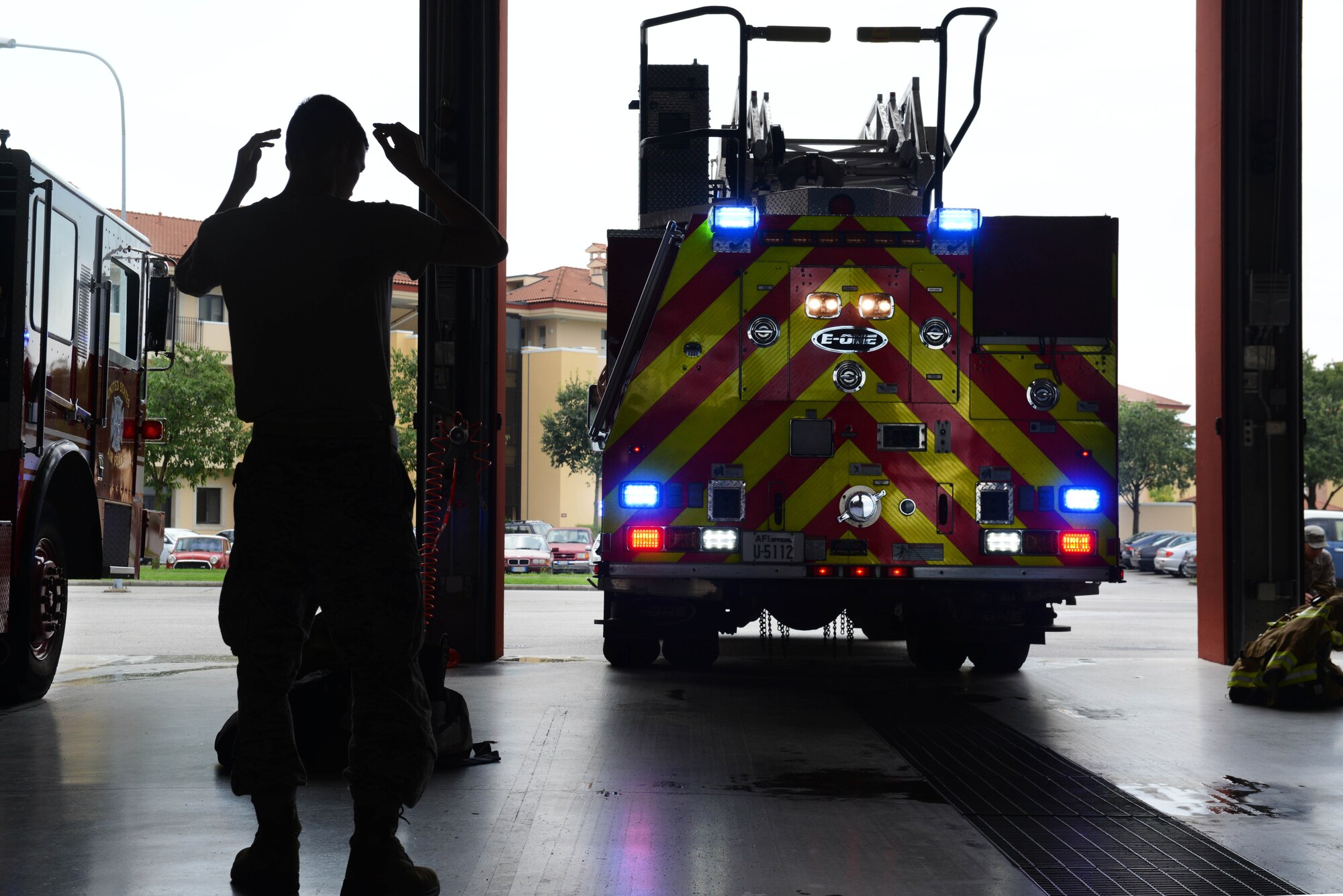 During an operations check, Airman 1st Class Joseph Cappel, 31st Civil Engineer Squadron firefighter, guides a fire truck into the Aviano firehouse, July 29, 2014, at Aviano Air Base, Italy. At the beginning of a 24-hour shift, firefighters conduct operations checks on the trucks to always be prepared for when they receive an emergency call. (U.S. Air Force photo/Airman 1st Class Ryan Conroy) 