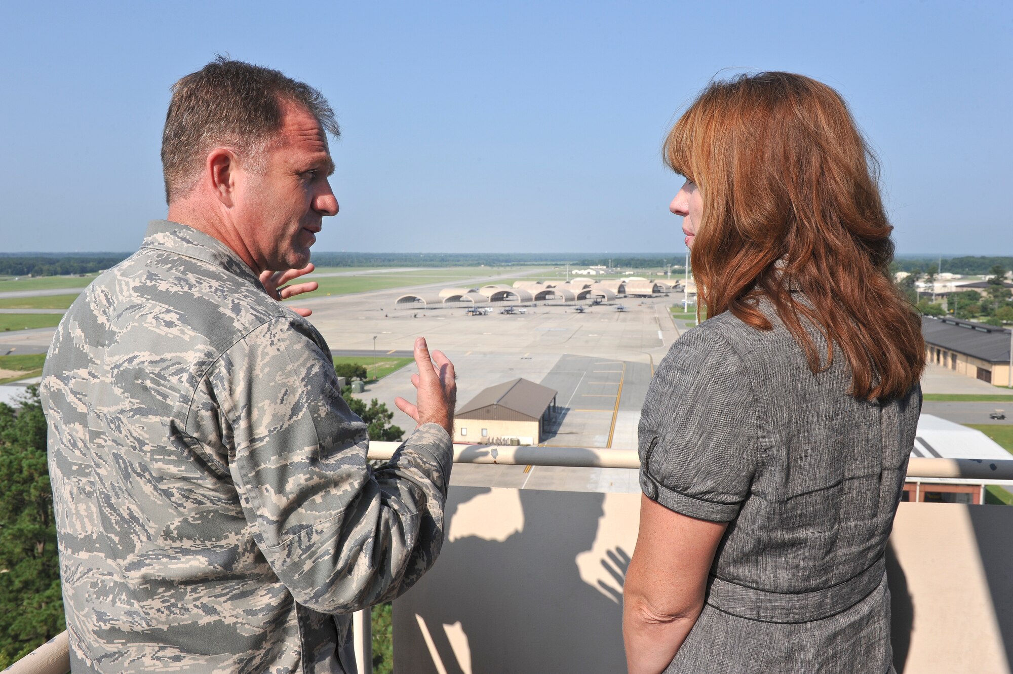 Col. Mark Slocum (left), 4th Fighter Wing commander, talks to Jennifer Gradnigo (right), military liaison for Senator Kay Hagan, about flight line operations July 30, 2014, at Seymour Johnson Air Force Base, North Carolina. Slocum explained to Gradnigo the impact that the installation has on the surrounding communities. (U.S. Air Force photo/Airman 1st Class Aaron J. Jenne)