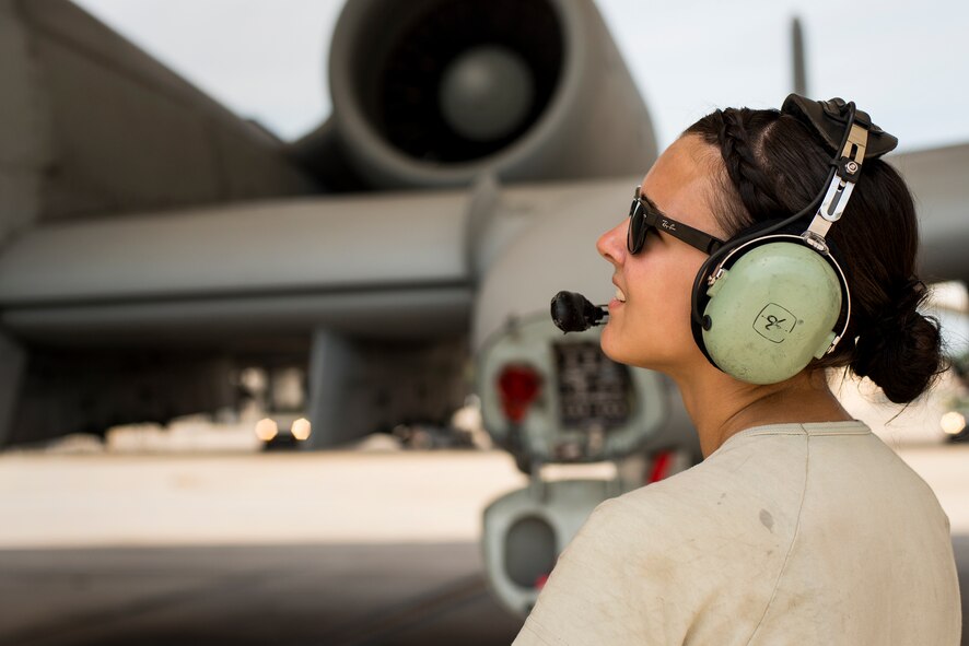 U.S. Air Force Airman 1st Class Megan Brill, 75th Aircraft Maintenance Unit crew chief, communicates with an A-10C Thunderbolt II pilot at Moody Air Force Base, Ga., July 30, 2014. During preflight inspections, the crew chief maintains constant conversation with the pilot to ensure the aircraft is ready to fly. (U.S. Air Force photo by Airman 1st Class Ryan Callaghan/Released)