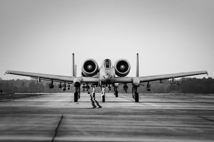 Two A-10C Thunderbolt II aircraft taxi towards the end of the runway at Moody Air Force Base, Ga., July 24, 2014. The A-10 primarily serves close air support, airborne forward air control and combat search and rescue functions. (U.S. Air Force photo by Airman 1st Class Ryan Callaghan/Released)