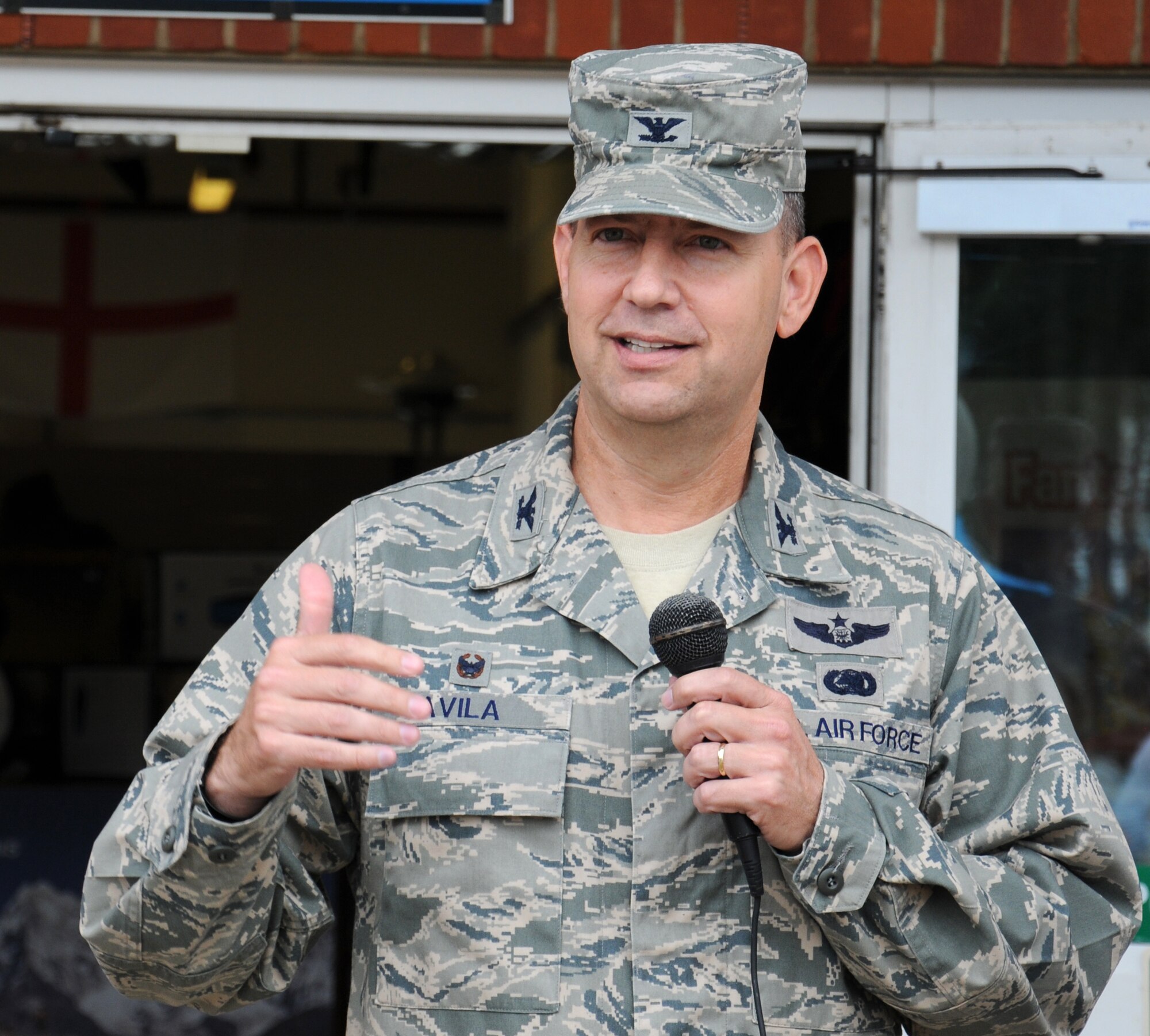U.S. Air Force Col. David Avila, 100th Mission Support Group commander, speaks to attendees at the outdoor recreation center re-opening event July 30, 2014, on RAF Mildenhall, England. Following the official re-opening, guests had the opportunity to look in the new store and talk to staff about the services the center provides. (U.S. Air Force photo/Gina Randall/Released)