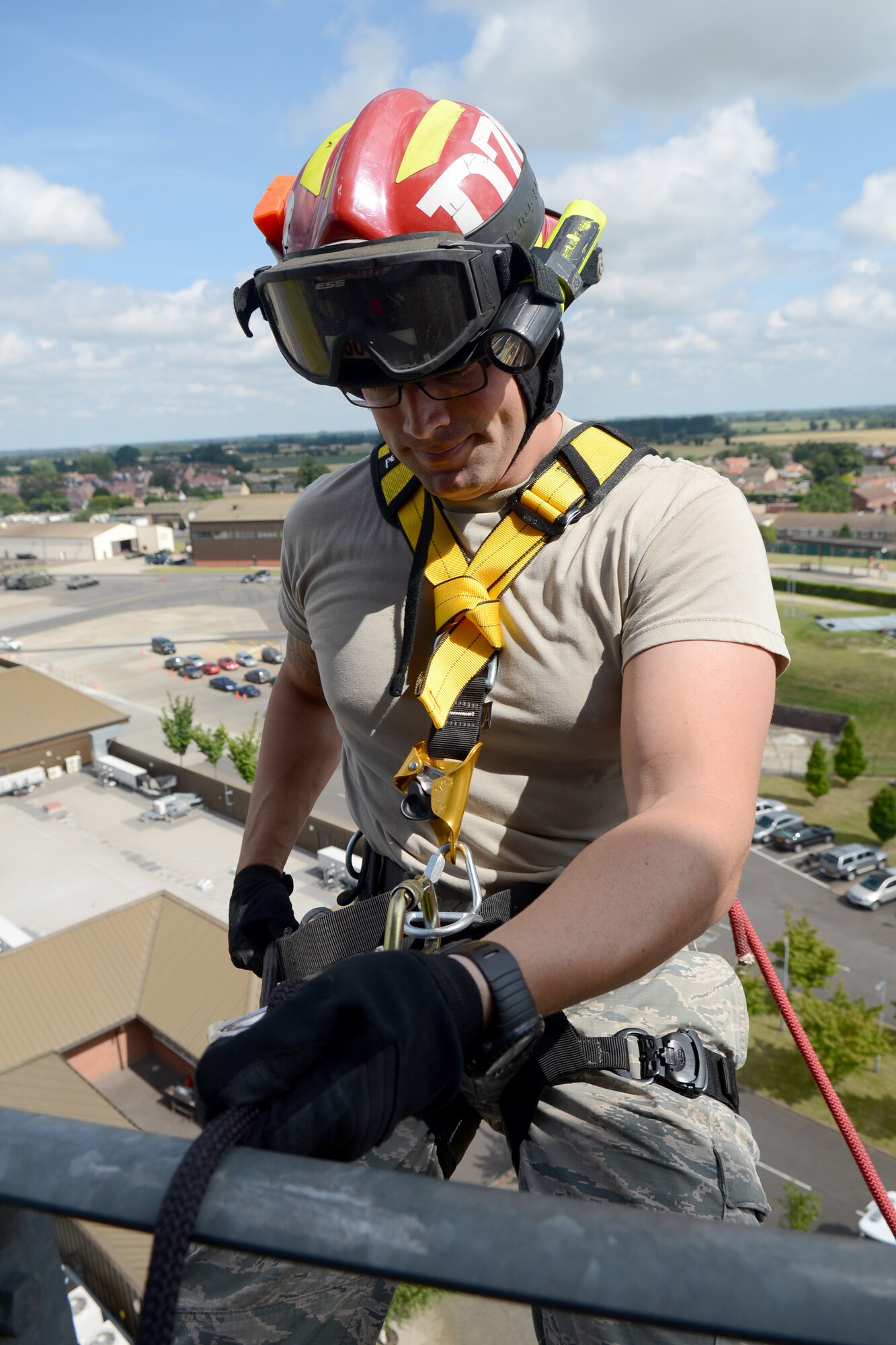 U.S. Air Force Staff Sgt. Kyle Dulin, 100th Civil Engineer Squadron Fire Department fire protection crew chief from Redondo Beach, Calif., prepares to rappel off the air traffic control tower July 17, 2014, on RAF Mildenhall, England. Firefighters train once a month on specialist rescues situations, including high-angle rescue and confined-space rescue. (U.S. Air Force photo/Airman 1st Class Kyla Gifford/Released)