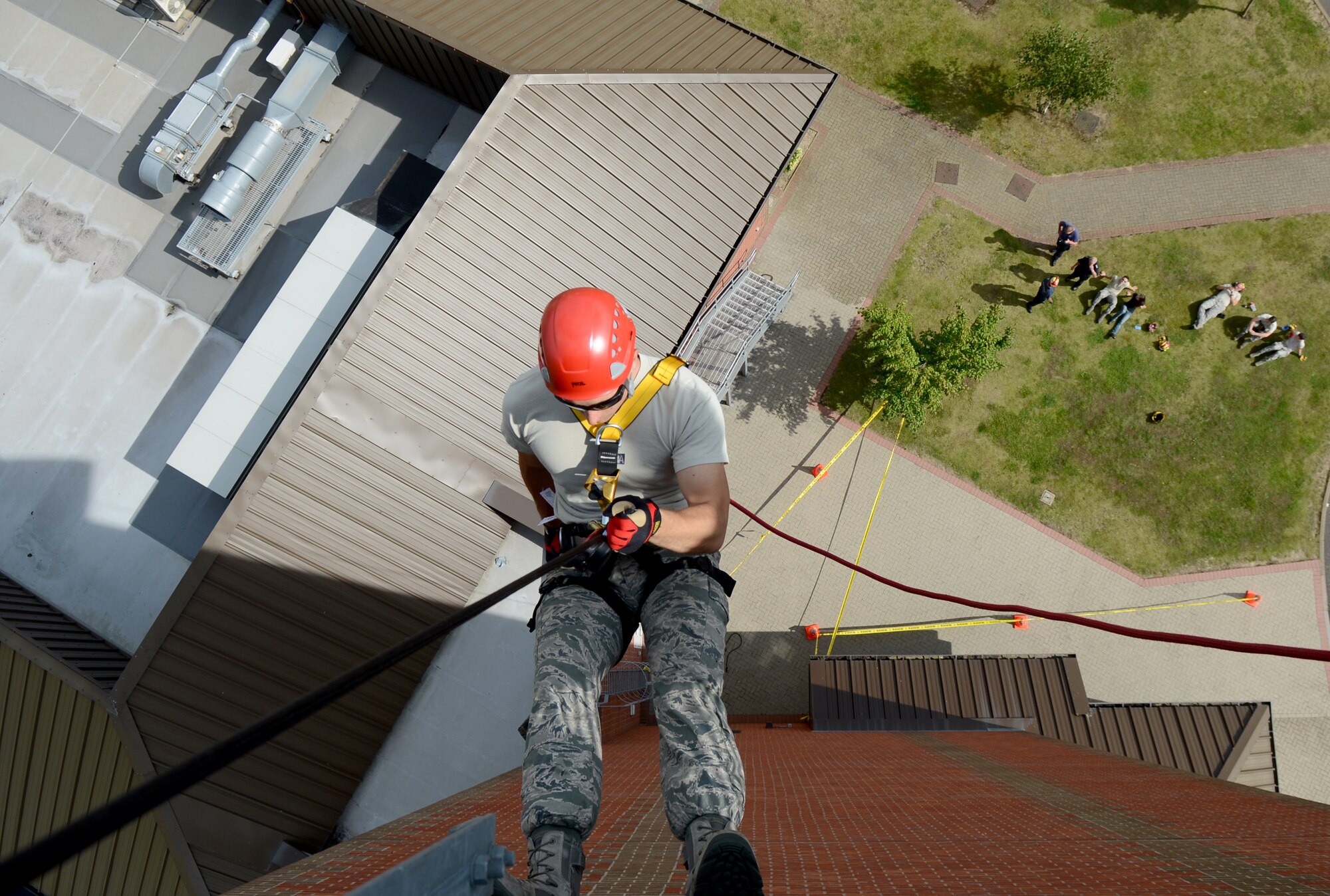 U.S. Air Force Staff Sgt. Christopher Bryant, 100th Civil Engineer Squadron Fire Department fire protection crew chief from Stockton, Calif., rappels down the air traffic control tower July 17, 2014, on RAF Mildenhall, England. Firefighters must train to be able to extract victims safely from any situation. (U.S. Air Force photo/Airman 1st Class Kyla Gifford/Released)