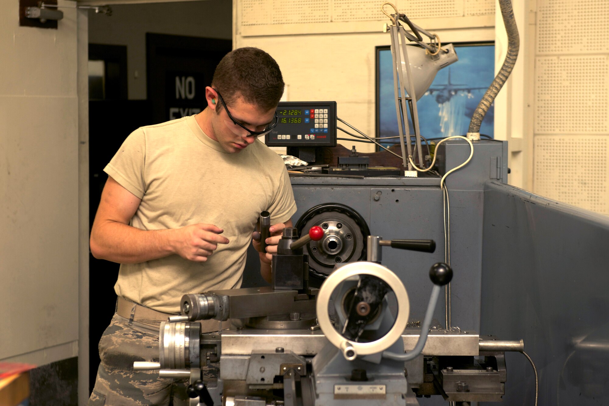 Airman 1st Class Curtis Doherty, 374th Maintenance Squadron aircraft metals technologist, prepares a lathe for welding at Yokota Air Base, Japan, July 24, 2014.  Doherty took part in hands-on training to receive job certification. (U.S. Air Force photo by Airman 1st Class David C. Danford/Released)