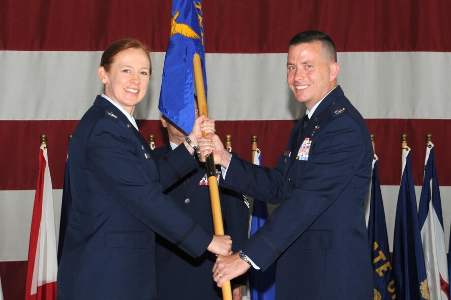 GOODFELLOW AIR FORCE BASE, Texas -- Col. Kimberlee P. Joos, 17th Training Wing Commander, passes the 17th Training Group guidon to Col. Michael Grunwald Jr., during a change of command ceremony at Louis F. Garland Department of Defense Fire Academy July 25. Grunwald assumed command of the 17th TRG from Col. Brendan M. Harris during a change of command ceremony. (U.S. Air Force photo/ Staff Sgt. Laura R. McFarlane) 