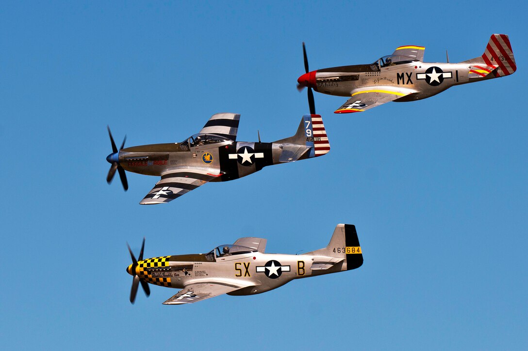 Pilots from the Bremont Horsemen Aerobatic Team fly their World War II-era P-51 Mustangs in a formation during the Arctic Thunder Open House on Joint Base Elmendorf-Richardson, Alaska, July 27, 2014.