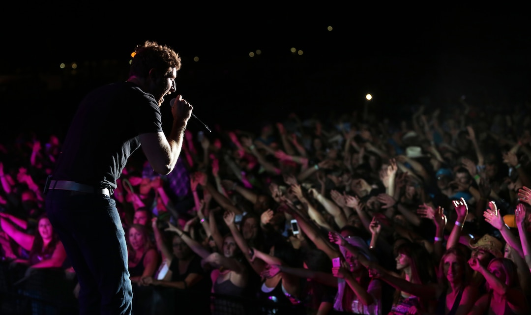Brett Eldredge, country music star, begins his headlining performance at the We Salute You celebration hosted at Lance Corporal Torrey L. Gray Field, May 17, 2014. The event featured musical performances from Eldredge, Little Texas and the Shuggah Pies.