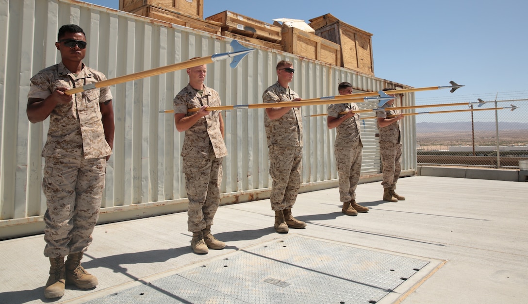 Marines with Marine Wing Air Support Squadron 374, 3rd Marine Air Wing, practice presenting guidons as a squad during a guidon manual class at the 1st Tank Battalion classroom lot, May 20, 2014. Corporal's Course teaches Marines the drill manual in the classroom and through practical application.