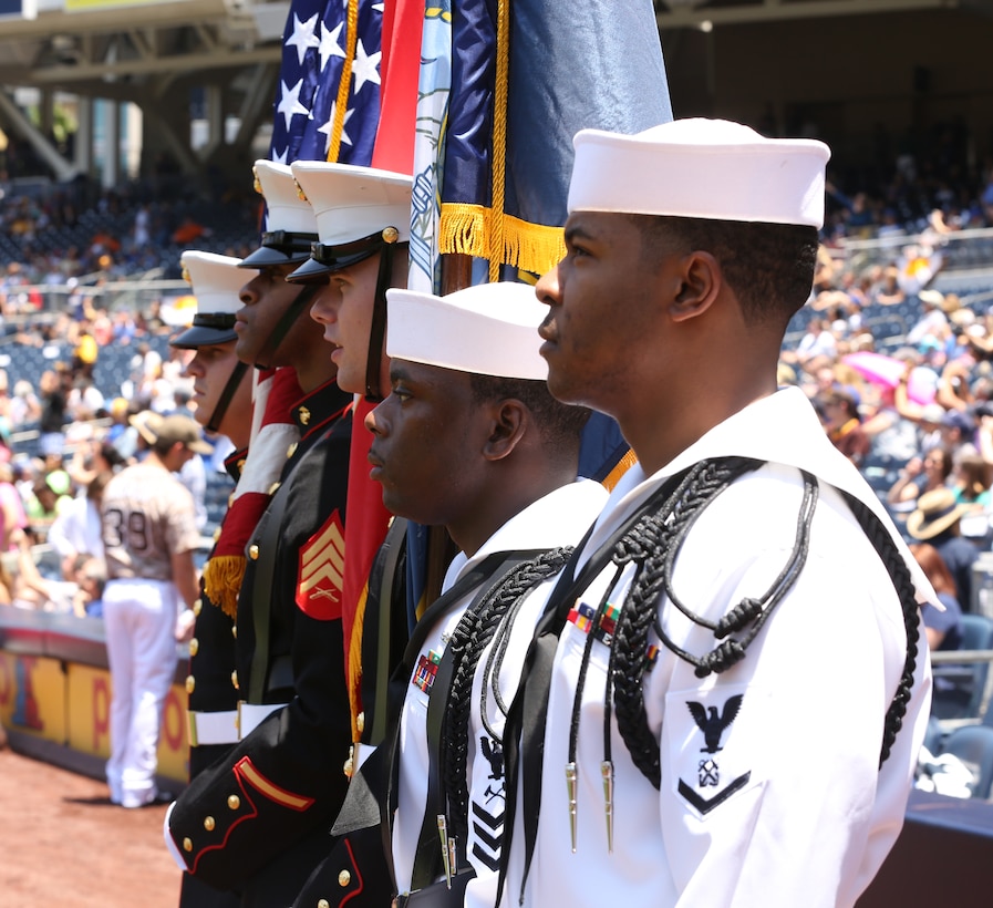 A joint Navy-Marine Corps color guard prepares to march on the colors during their appearance at a military appreciation ceremony at a San Diego Padres baseball game at Petco Park, May 25, 2014. Uniformed service members saluted the colors alongside hundreds of veterans in the crowd.