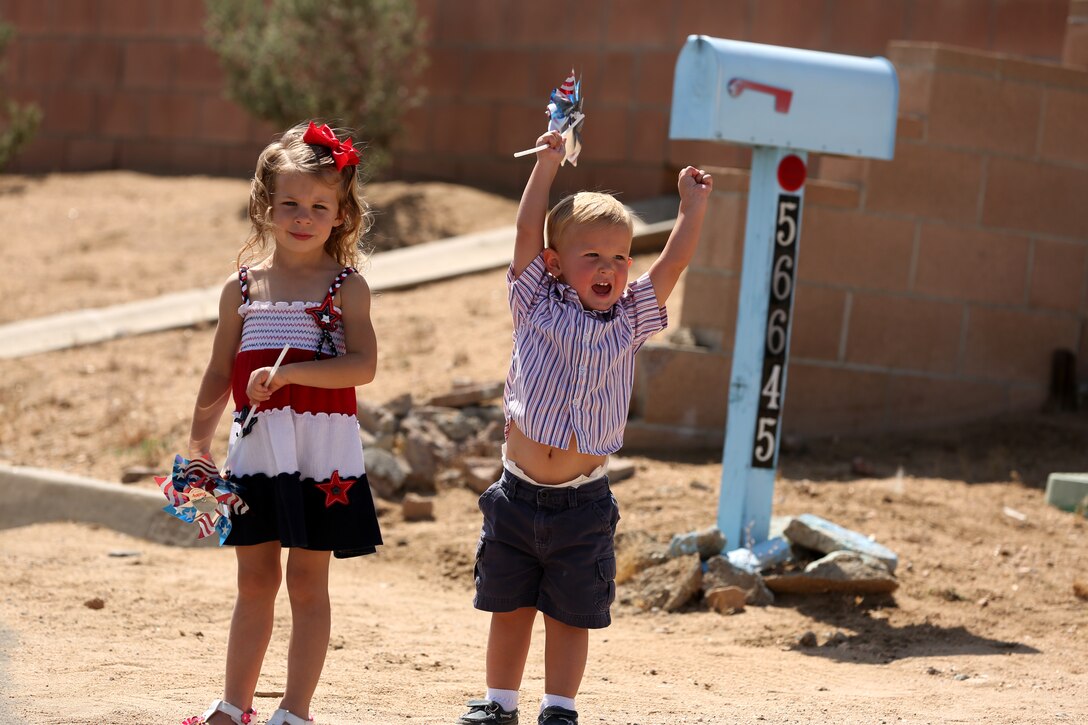 John Ferry, 2, cheers for the 3rd Light Armored Reconnaissance Battalion color guard during the Grubstake Days Parade held in Yucca Valley, Calif., May 24, 2014. As they passed by, people on the sides of Onaga Trail stood to honor the colors.