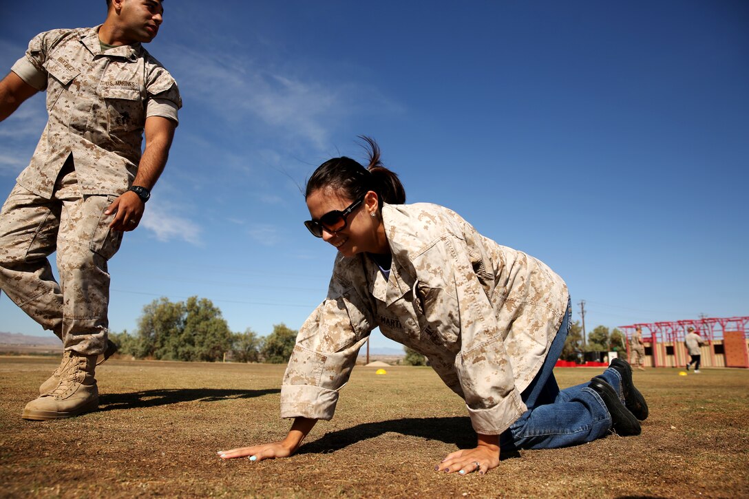 Katherine Martinez, wife of Sgt. Lenny Martinez, Unmanned Aerial Vehicle mechanic, Unmanned Aerial Vehicle Squadron 1, conducts the high crawl during a modified Combat Fitness Test as a part of the unit's Jayne Wayne Day May 23, 2014.