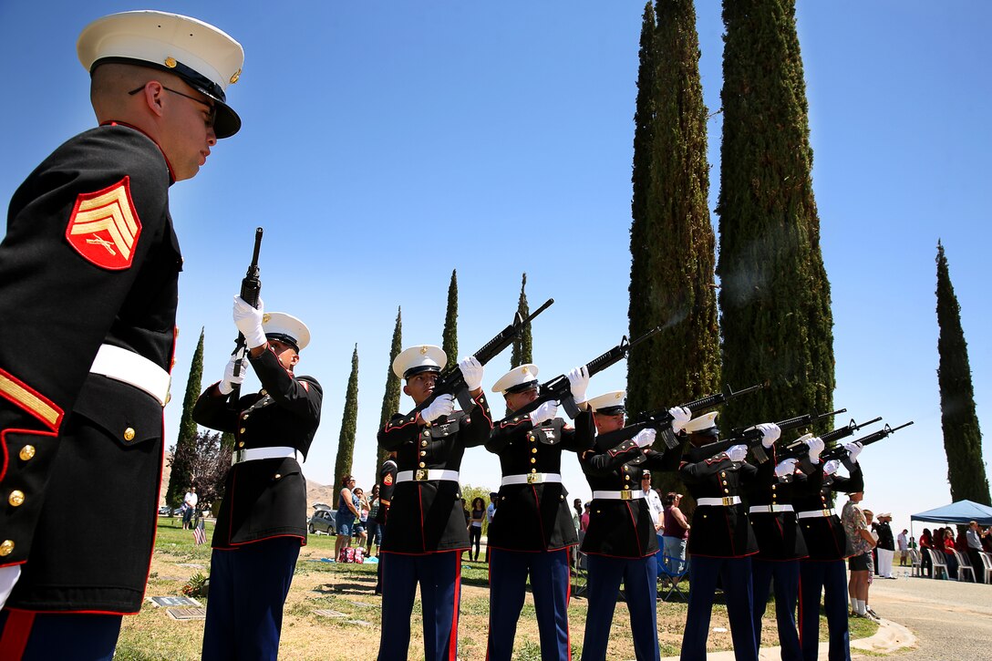 Marines with Headquarters Battalion conduct a rifle salute during the Memorial Day ceremony at Joshua Tree Memorial Park and Mortuary May 26, 2014. The event was dedicated to the remembrance of service members who made the ultimate sacrifice.