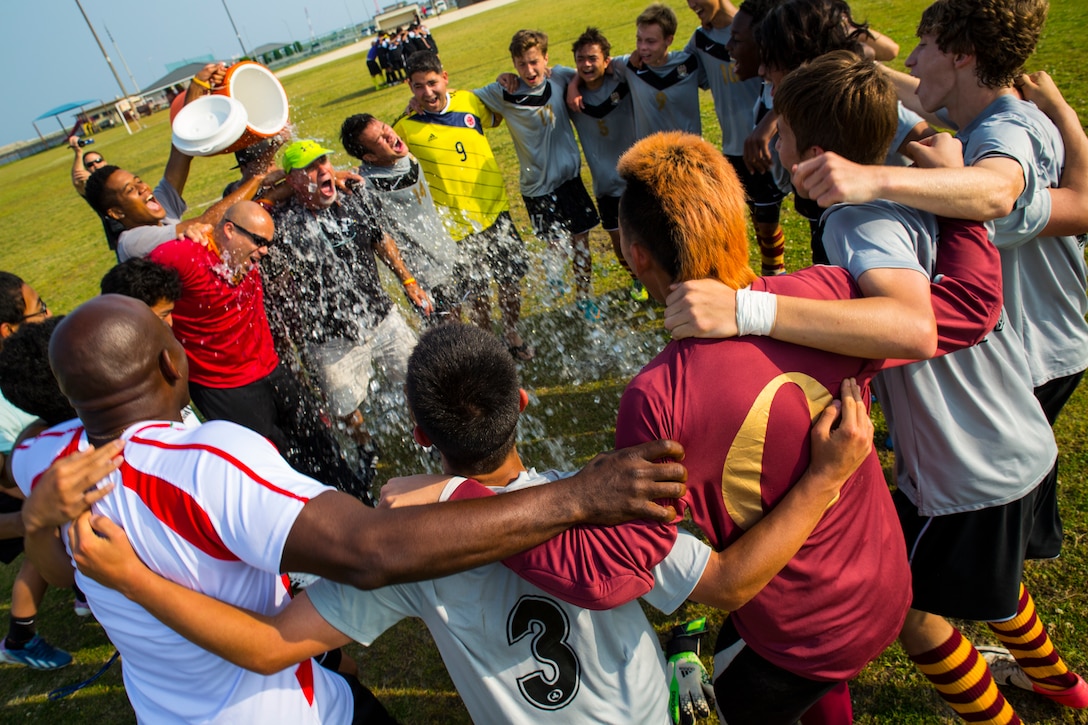 Players dump a cooler of water on Mark Lange, head coach of Matthew C. Perry High School boy’s soccer team, after their victory at the Department of Defense Education Activities Far East Boys championship soccer game aboard MCAS Iwakuni, May 22, 2013. This marks the 11th season and fourth DoDEA Far East Division Two Boys soccer championships for Lange at Perry. Iwakuni secured a 3-1 victory over U.S. Army Garrison Camp Zama, Japan, during the championship game of the tournament. 