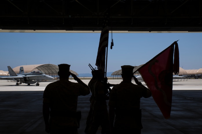 Lt. Col. Bruce D. Gordon, left, and Lt. Col. Shawn M. Basco salute colors during the pass and review at the Marine All-Weather Fighter Attack Squadron change of command aboard Marine Corps Air Station Iwakuni, Japan, May 23, 2014. Basco looks forward to continuing the legacy and filling the shoes Gordon left behind.
