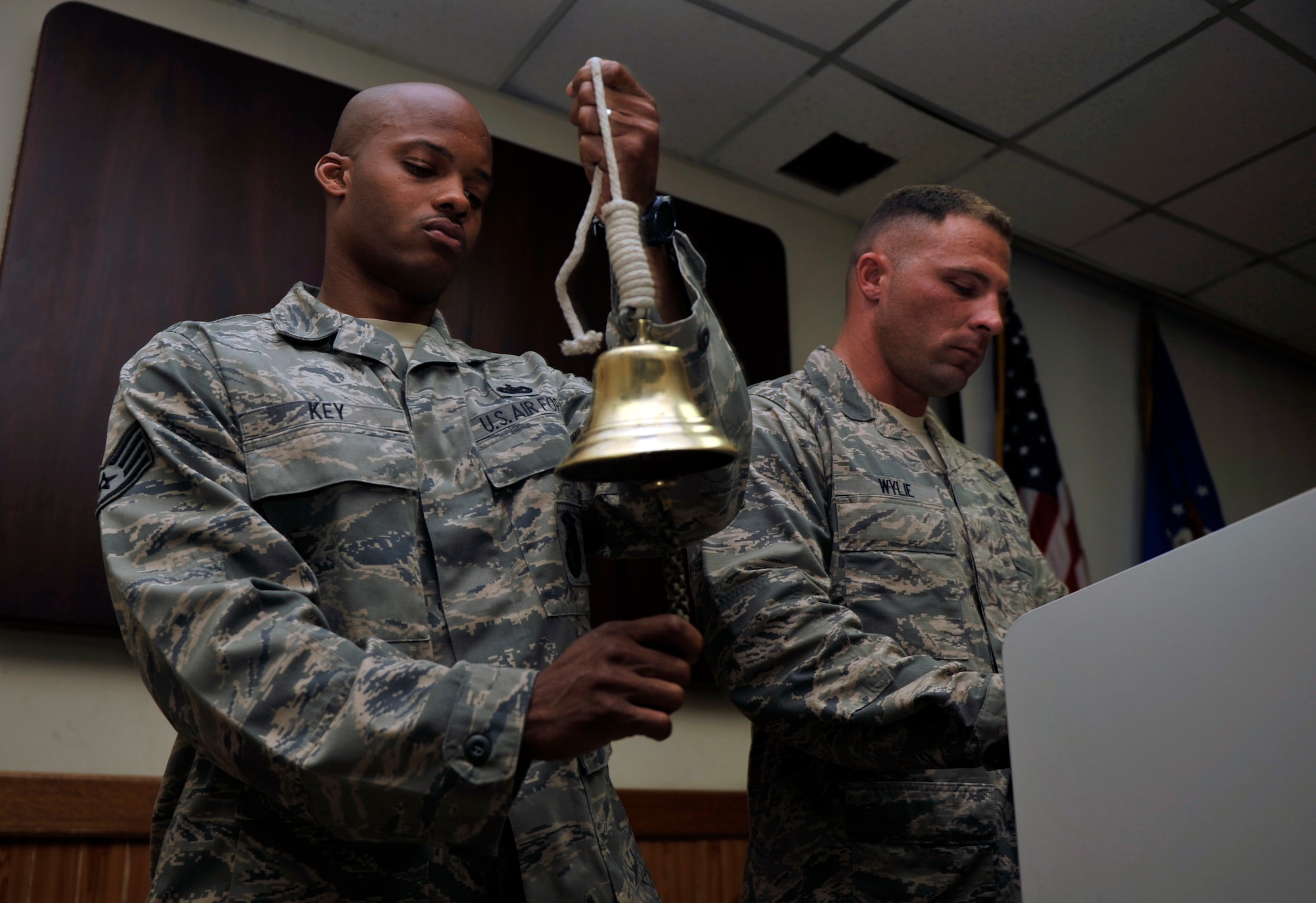 Staff Sgt. John Key, 51st Security Forces Squadron military working dog handler, rings a bell to signify bringing the dog home during Military Working Dog Reza’s memorial service May 30, on Osan Air Base, Republic of Korea. The third ringing of the bell signifies that the dog had laid his head down to rest and their journey has ended. (U.S. Air Force photo by Senior Airman David Owsianka)